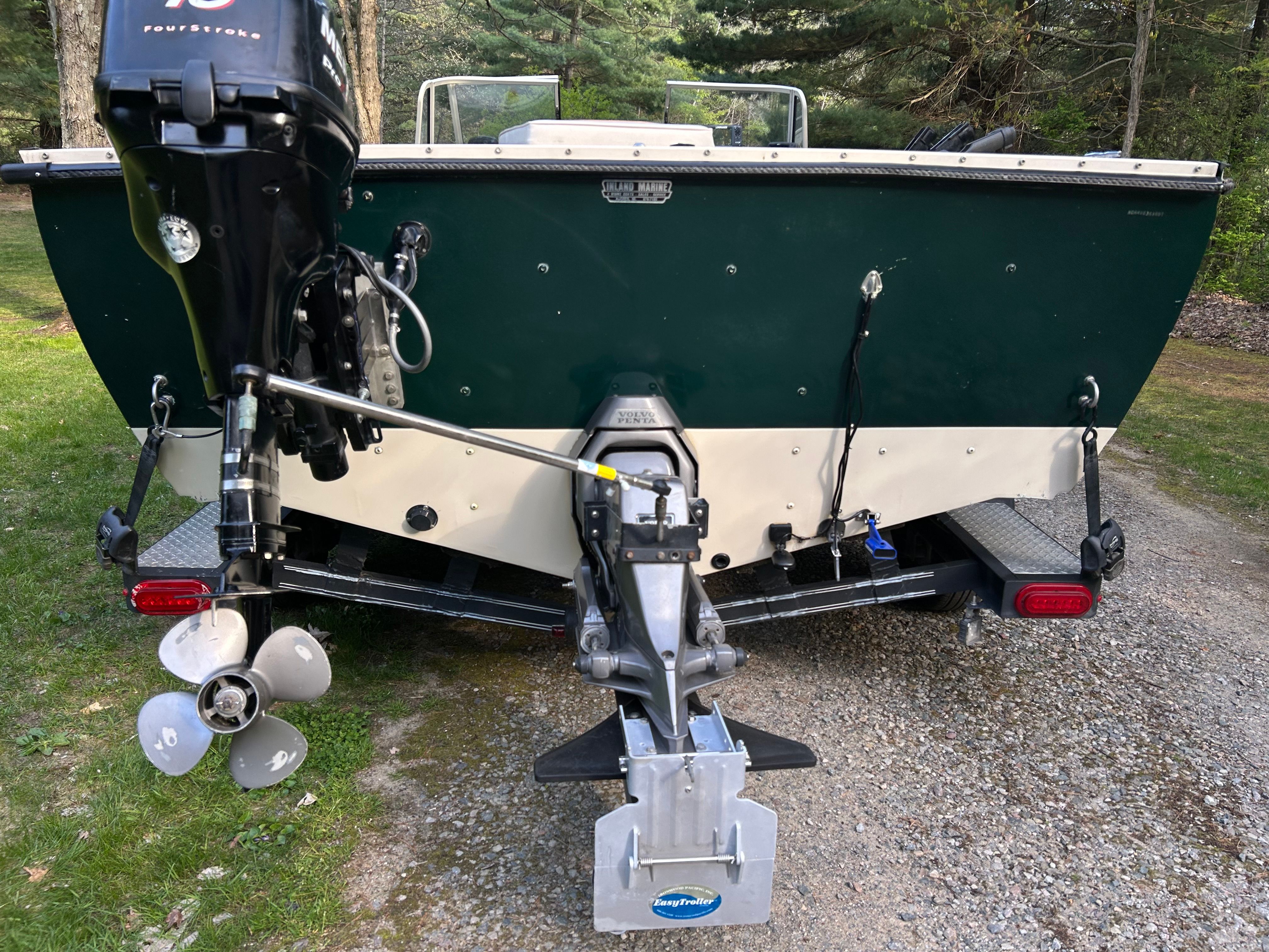 Rear view of a 1997 Crestliner 2050 Sportfish boat with outboard motor.