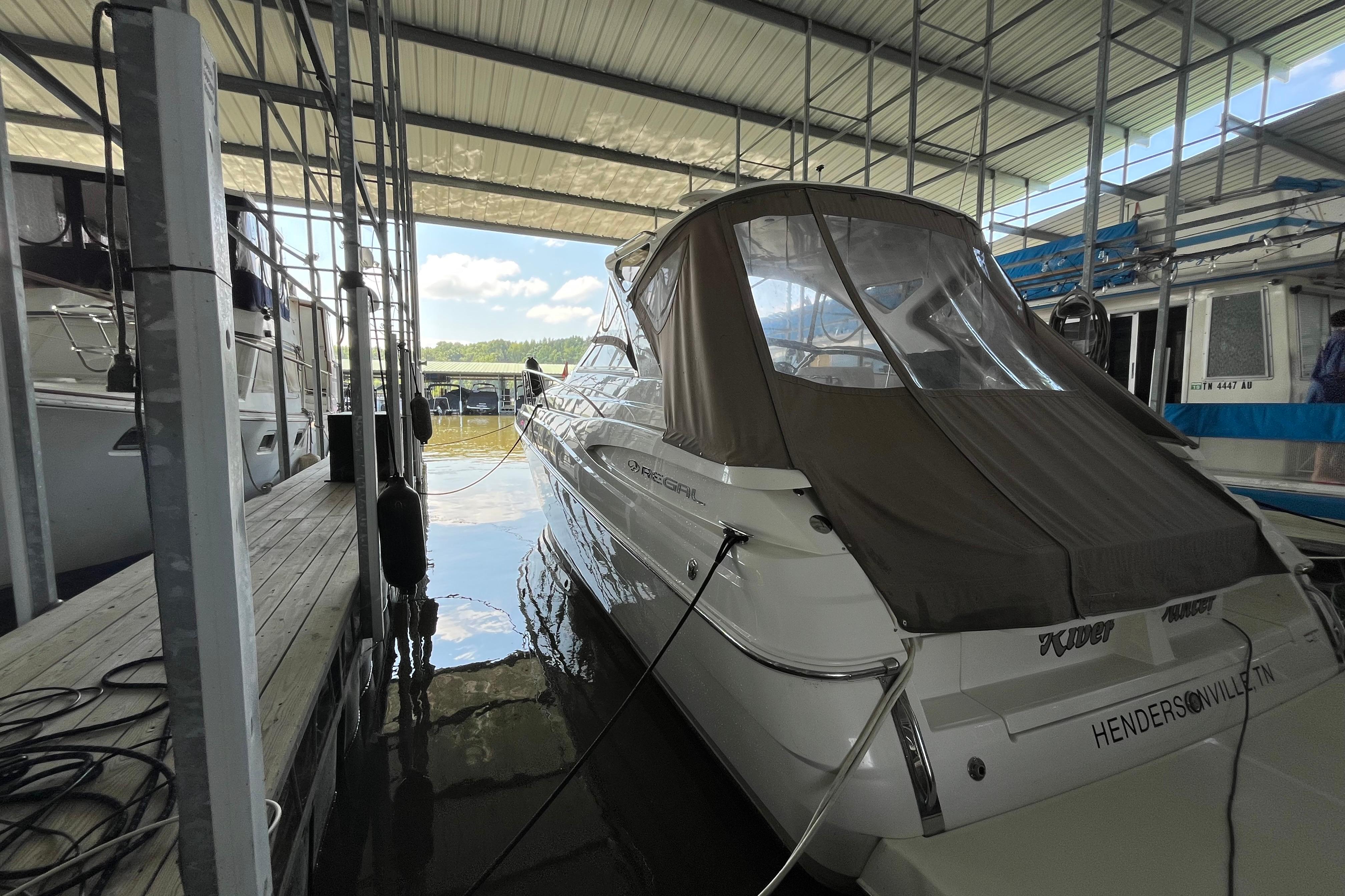 2007 Regal 3760 IB Commodore docked in a covered marina.