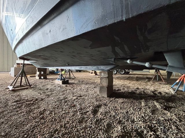 A 2004 Meridian 341 Sedan is supported on blocks in a storage facility.