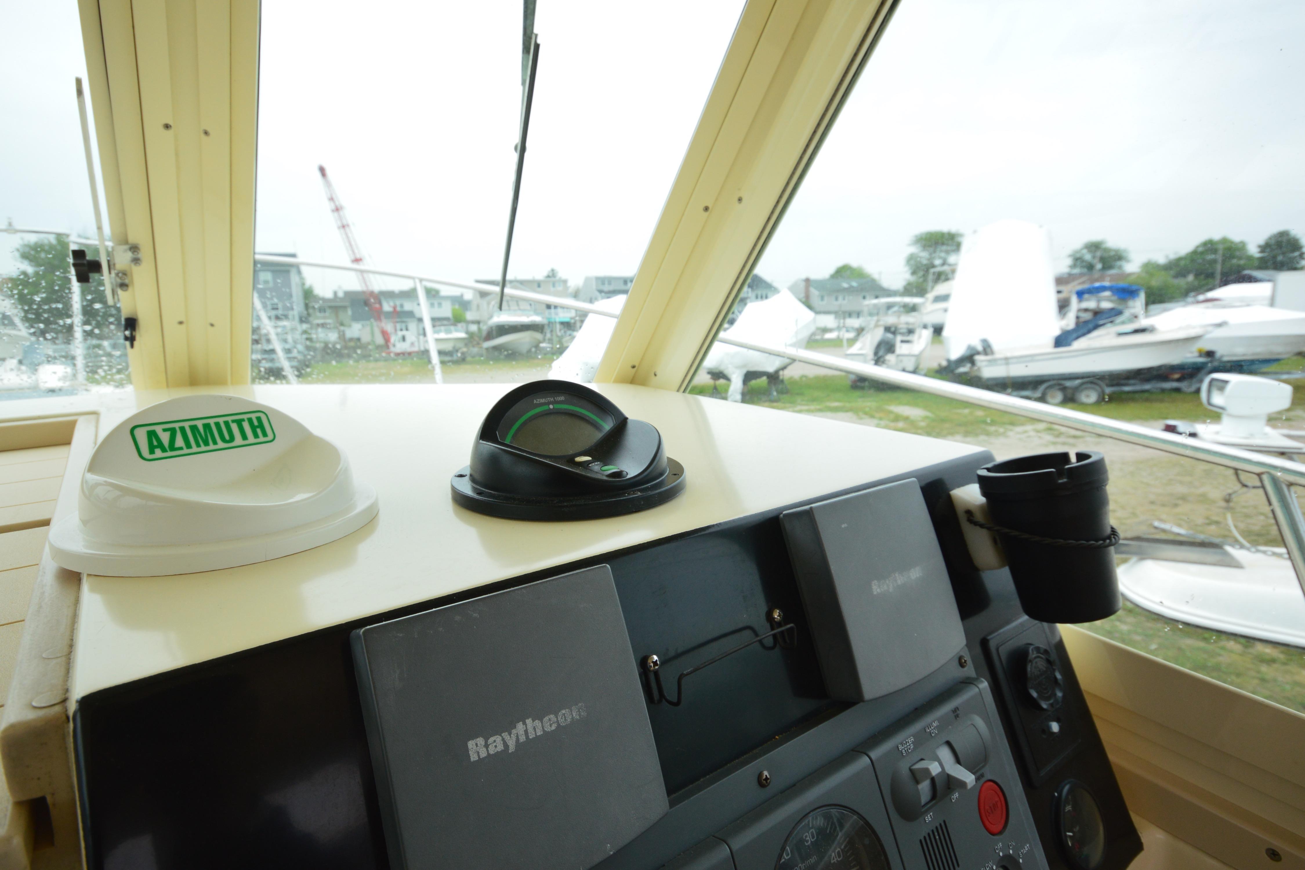 Helm of 2001 Albin 28 Tournament Express with navigation instruments and outdoor view.
