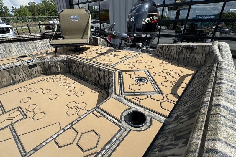 2026 Excel 183 Tomahawk boat interior with hexagonal pattern flooring and Yamaha outboard motor.