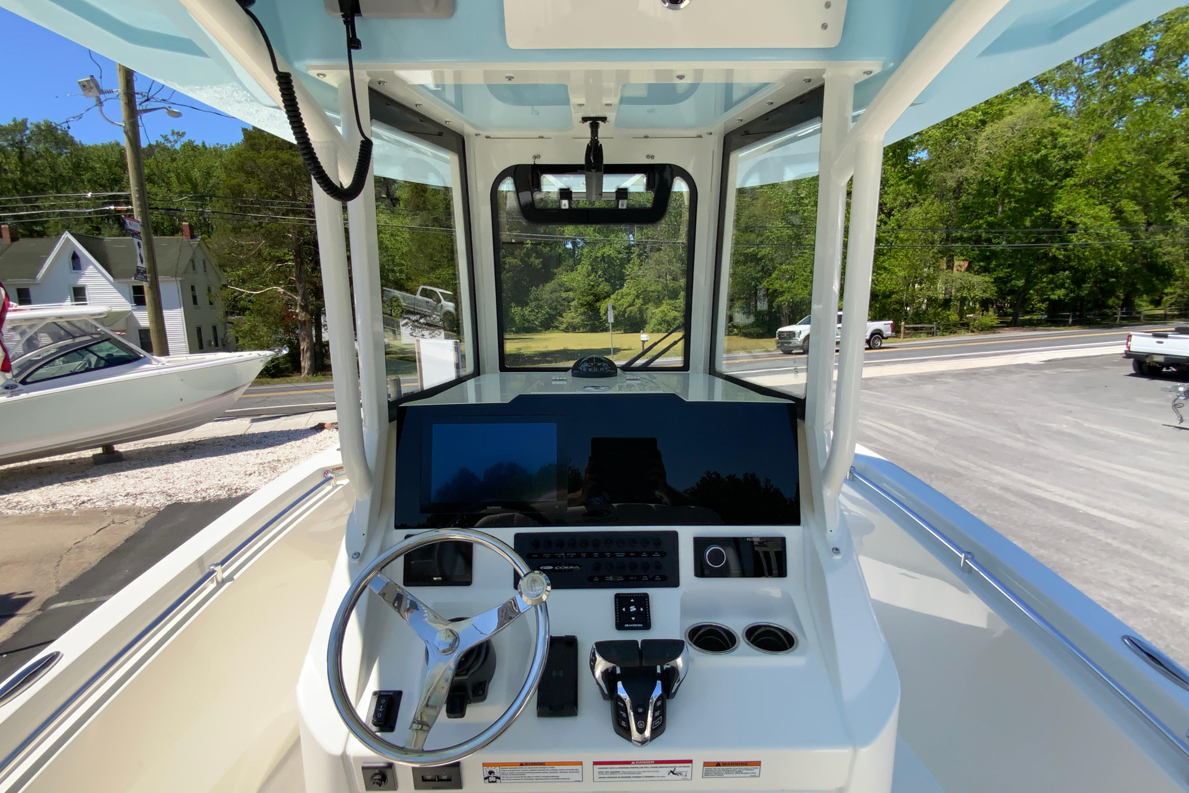 2026 Cobia 245 Center Console boat dashboard with steering wheel and controls.