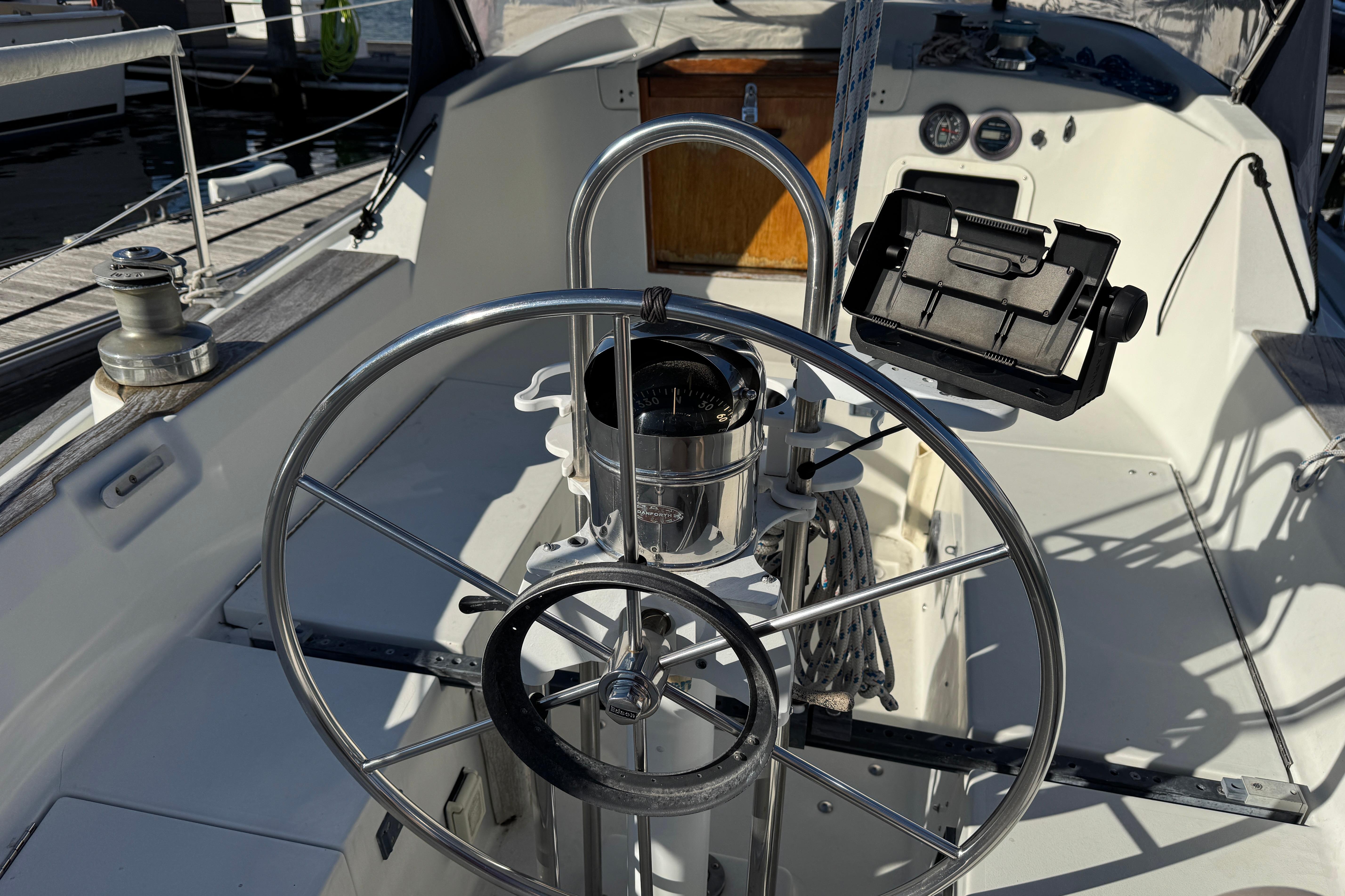 1984 C&C Landfall yacht cockpit with steering wheel and navigation instruments.