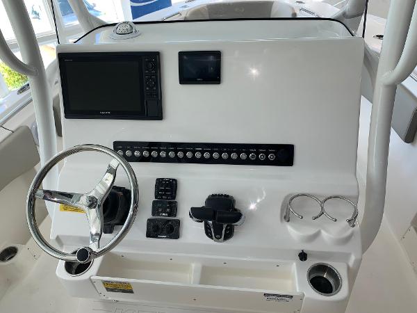 2024 Key West 263 FS boat dashboard with steering wheel, navigation system, and control panel.