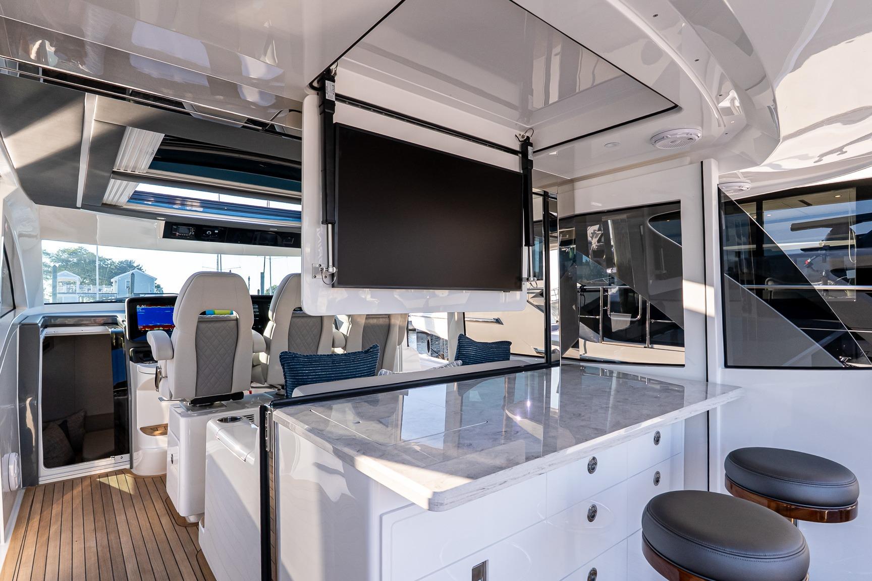 Luxurious interior of 2026 Valhalla V-55 Sport Yacht with modern seating and entertainment system.