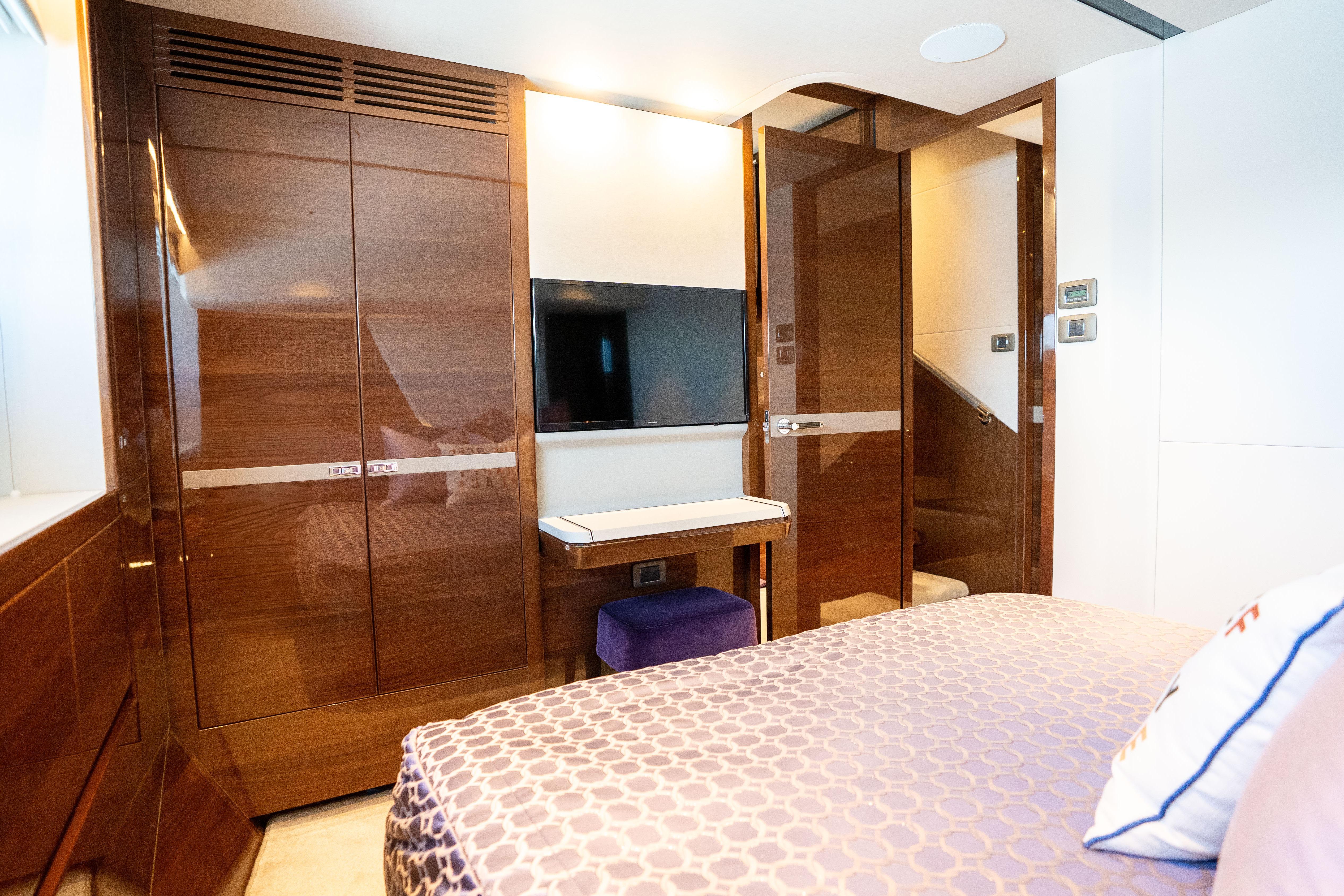 Luxurious cabin interior of 2020 Princess Y85 yacht with elegant wood finishes and modern amenities.