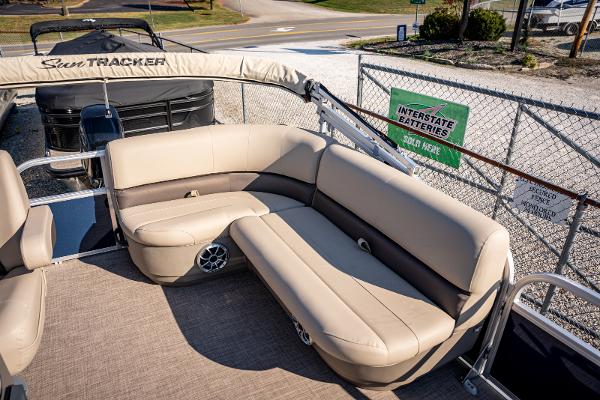 2025 Sun Tracker Bass Buggy 16 DLX pontoon boat with beige seating and spacious deck.