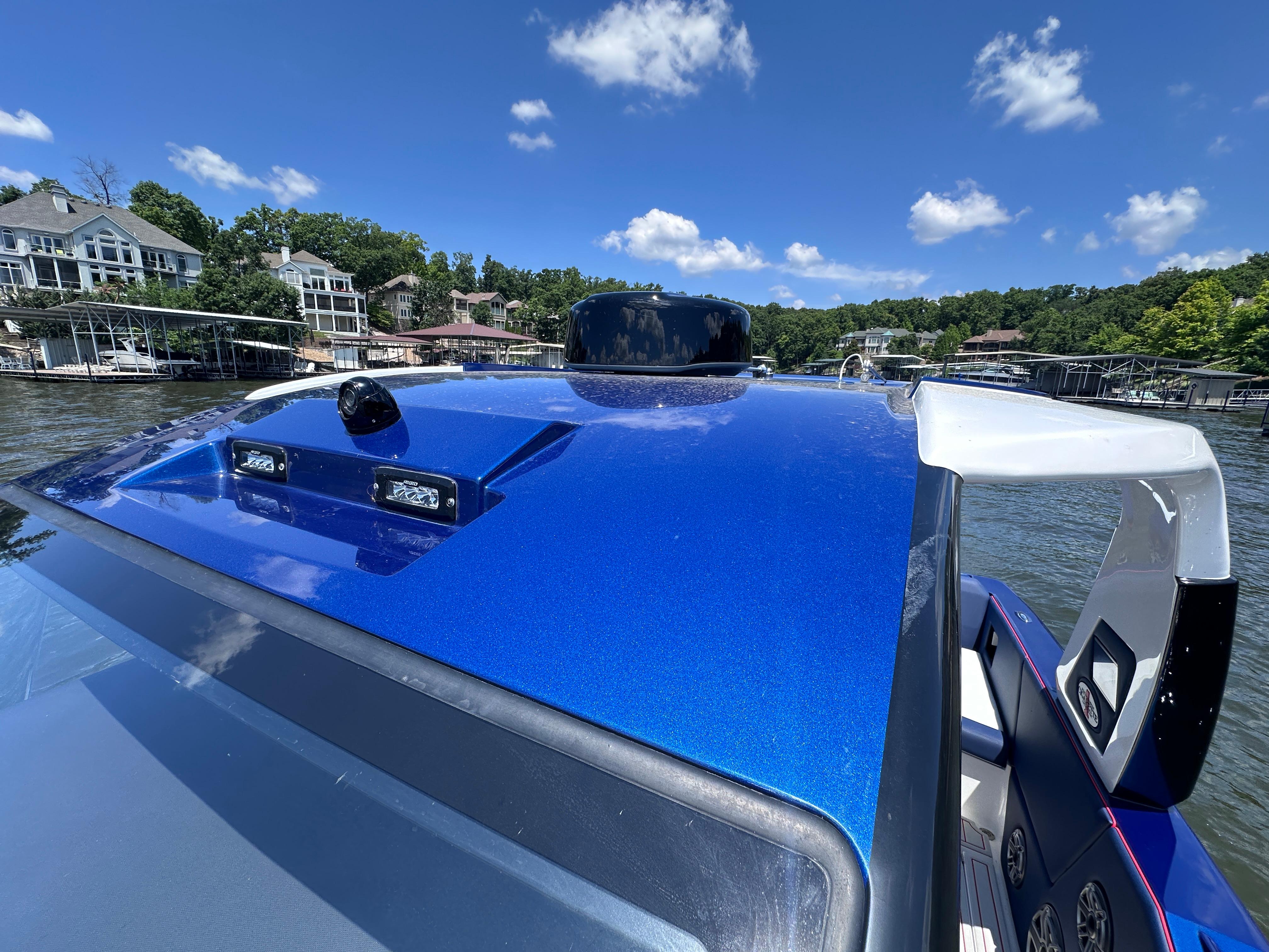 2024 Cigarette 42 Auroris boat with blue metallic finish on a sunny day.