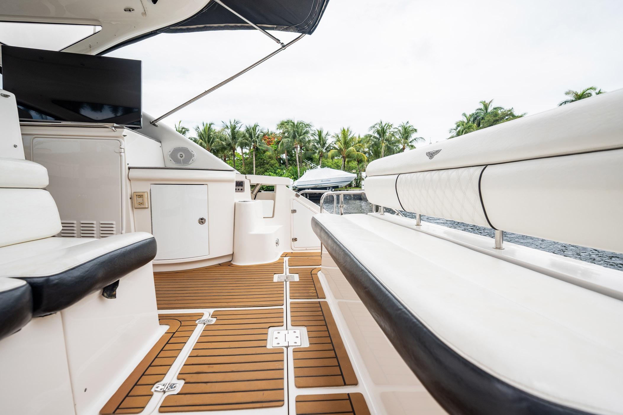 Luxurious 2008 Regal Commodore 4460 yacht interior with elegant seating and teak flooring.