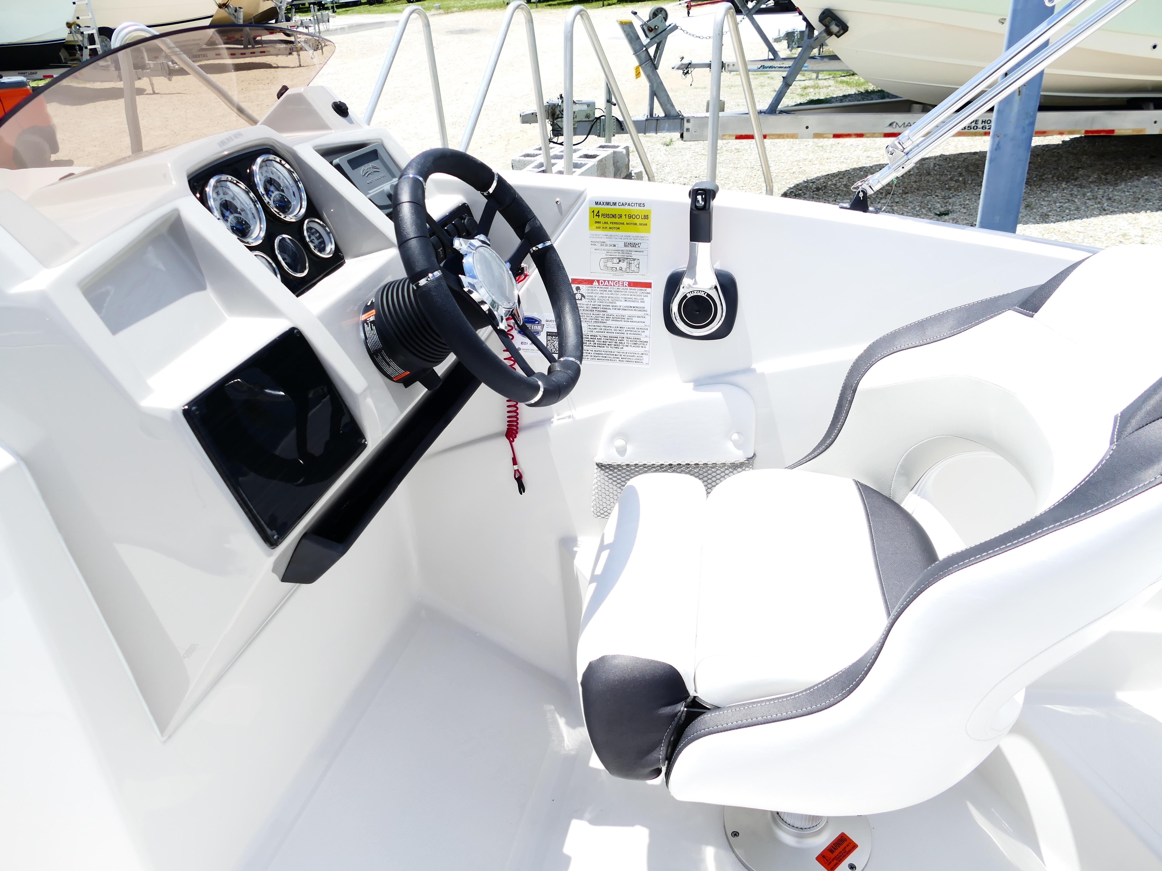 2026 Starcraft SVX 231 OB DH boat cockpit with steering wheel and control panel.