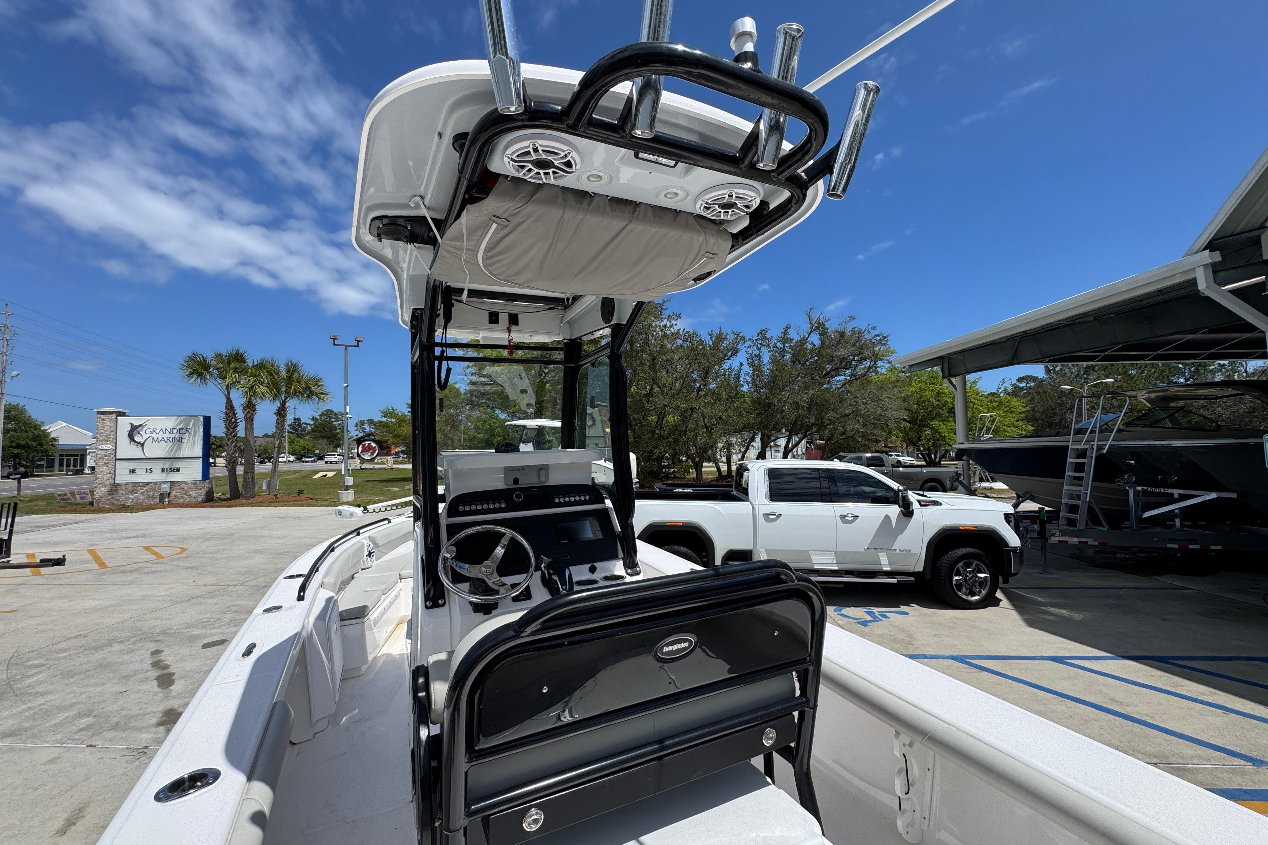 2022 Everglades 243 Center Console boat at marina with clear blue sky.