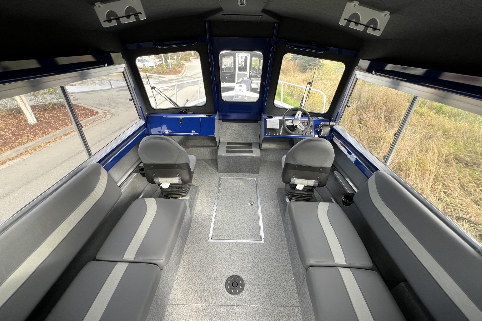 2024 Spartan 26 Maximus Pro XL interior with seating and steering console.