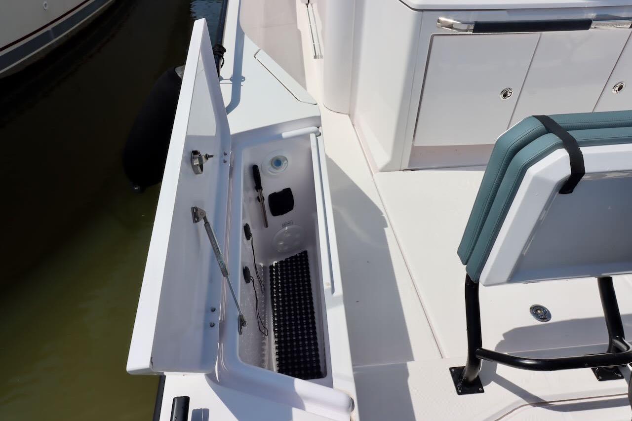 2022 Axopar 37 XC Cross Cabin boat interior with open storage compartment.