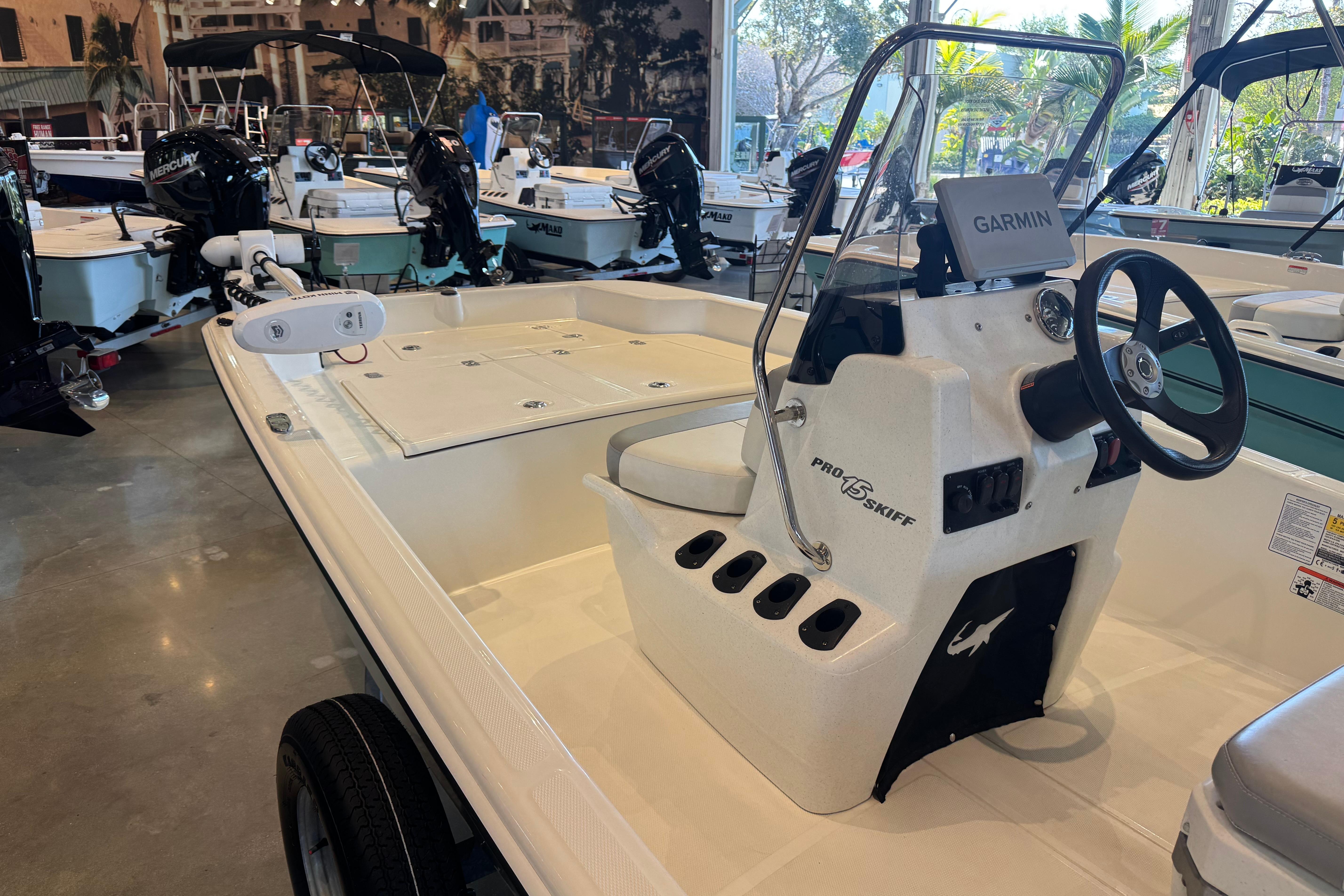 2025 Mako Pro Skiff 15 CC boat with Garmin navigation system in showroom.