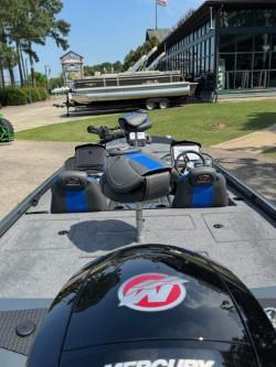 Ranger RT198P 2025 boat with Mercury engine in a parking area.