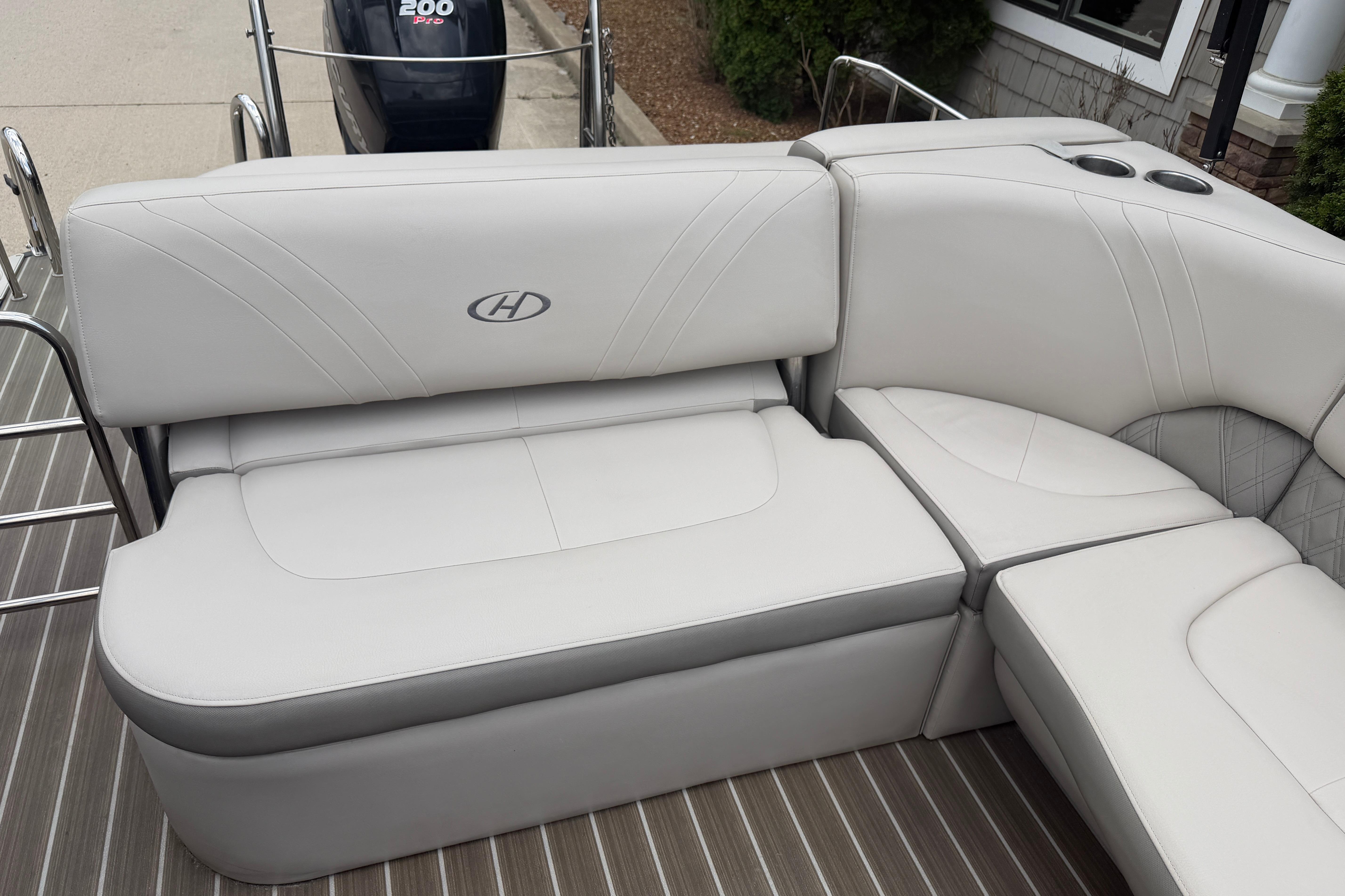 2019 Harris Solstice 240 boat interior with white cushioned seating and sleek design.