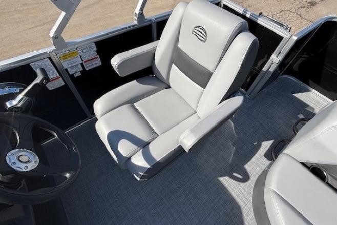 2026 Sun Tracker Party Barge 18 DLX captain's chair and steering wheel, featuring sleek design.