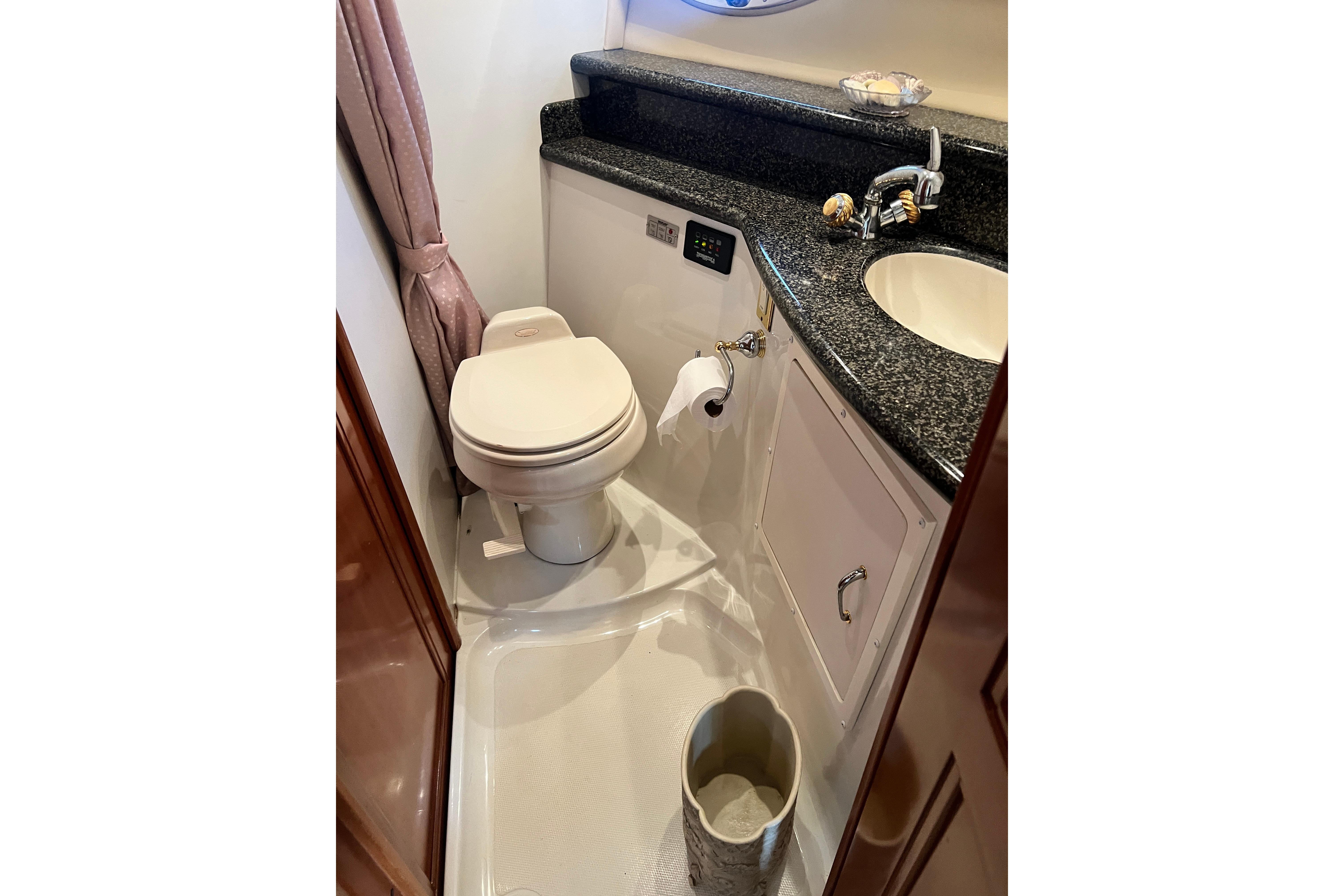 Bathroom interior of 2003 Carver 450 Voyager Pilothouse with toilet and sink.