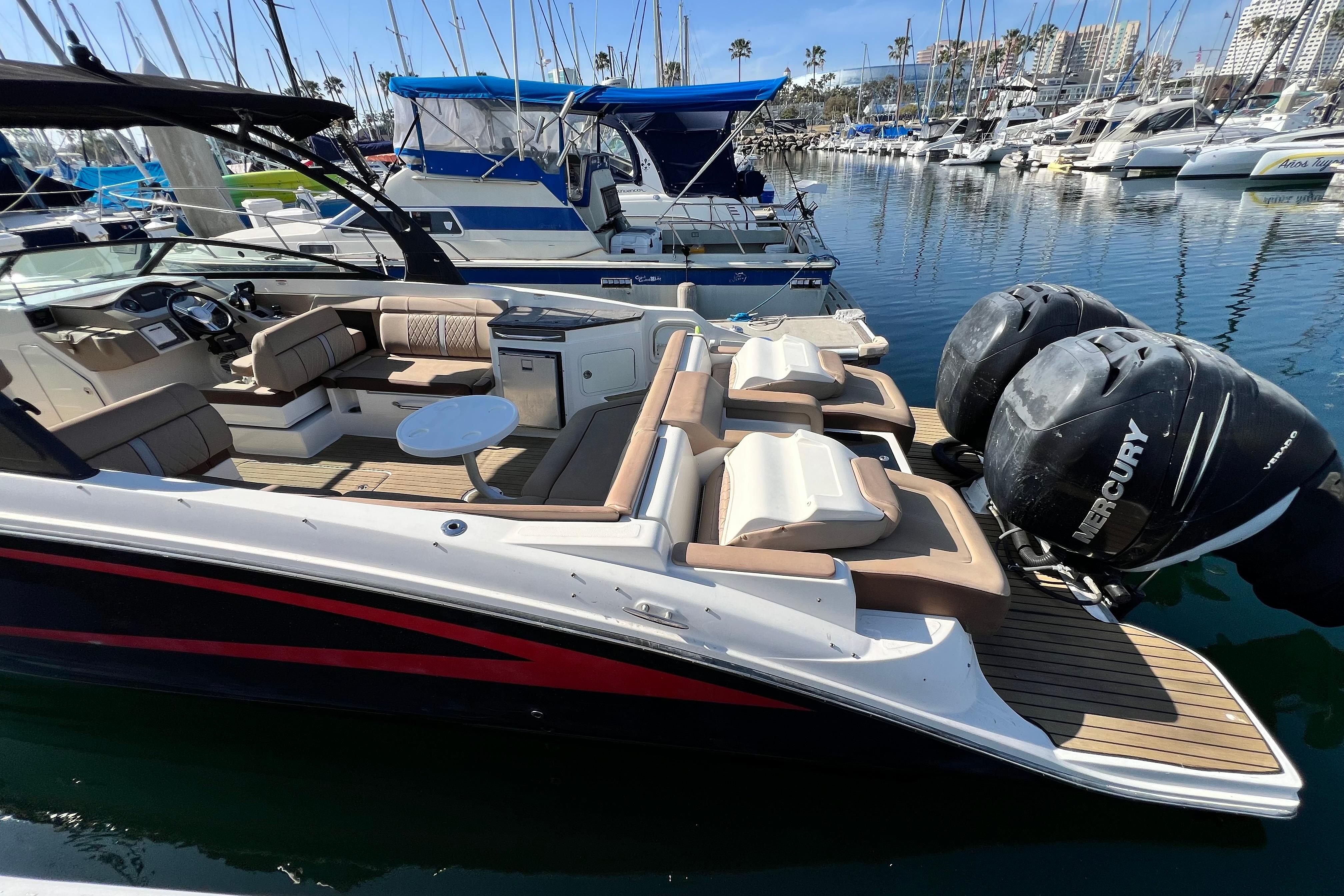 2016 Sea Ray 290 Sundeck Outboard with twin Mercury engines docked in marina.