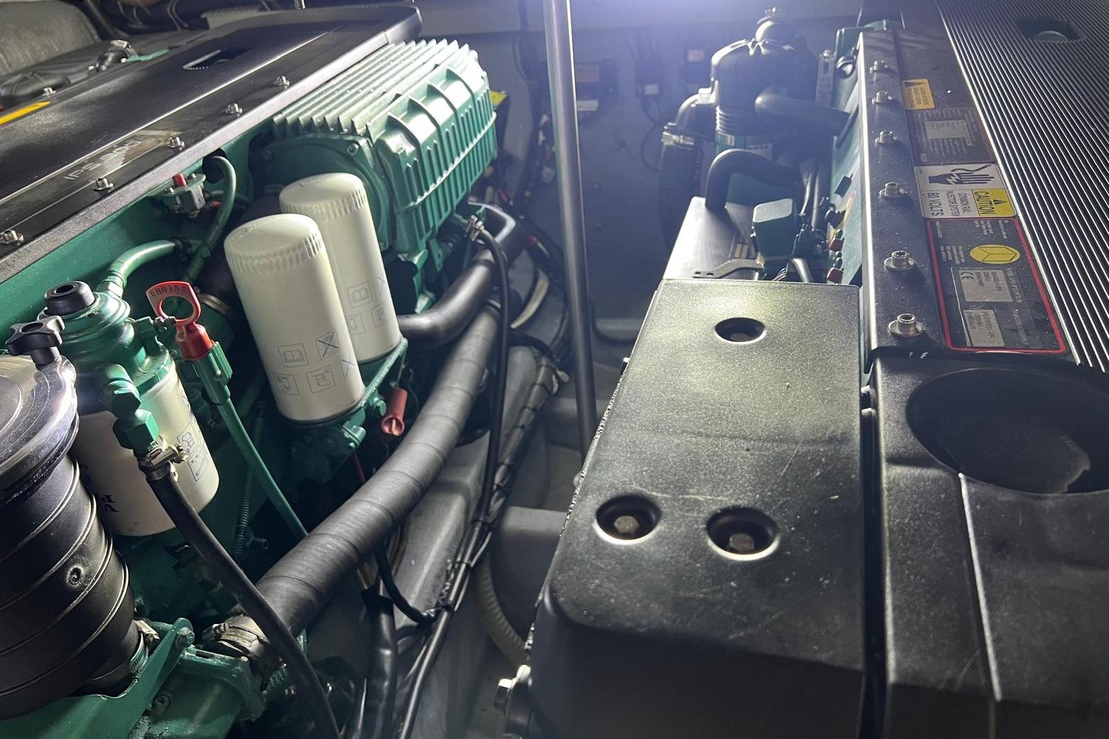 Engine room of a 2007 Absolute 56 yacht, showcasing detailed machinery components.