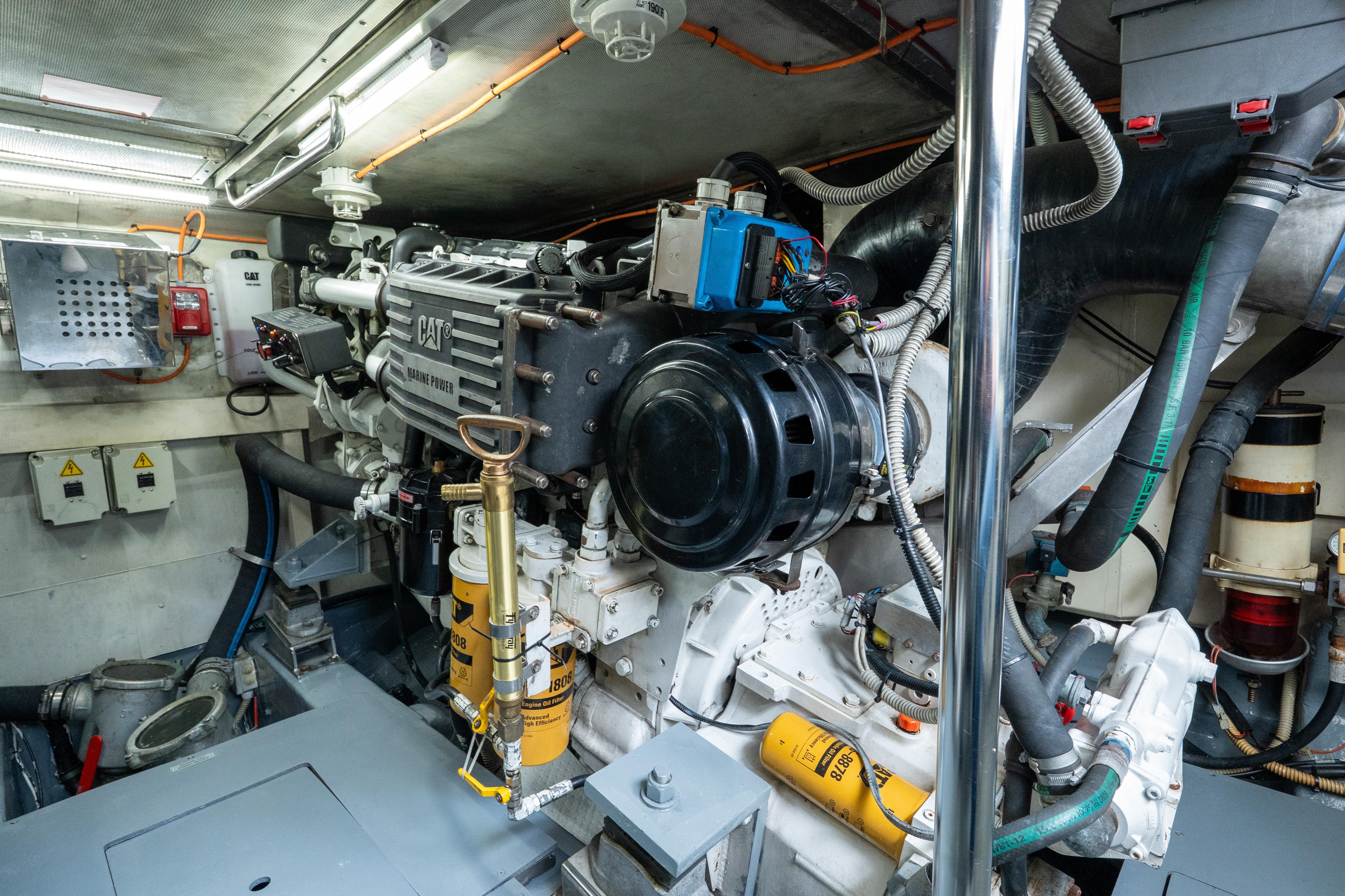 Engine room of a 2008 Azimut 62E yacht, featuring a CAT marine engine.