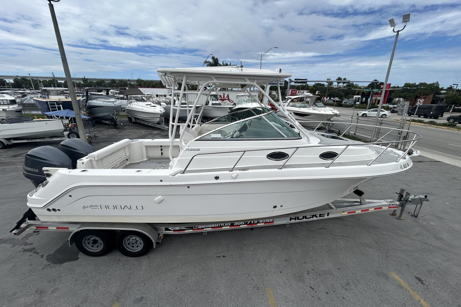 2018 Robalo R305 Walkaround boat on trailer at marina, side view.