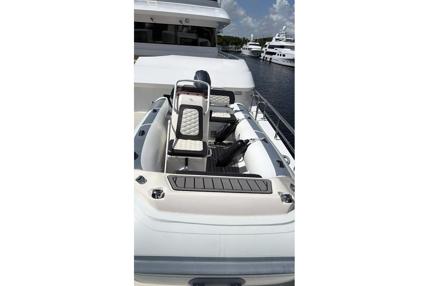 2022 Highfield Sport 420 boat with sleek seating, docked near luxury yachts.