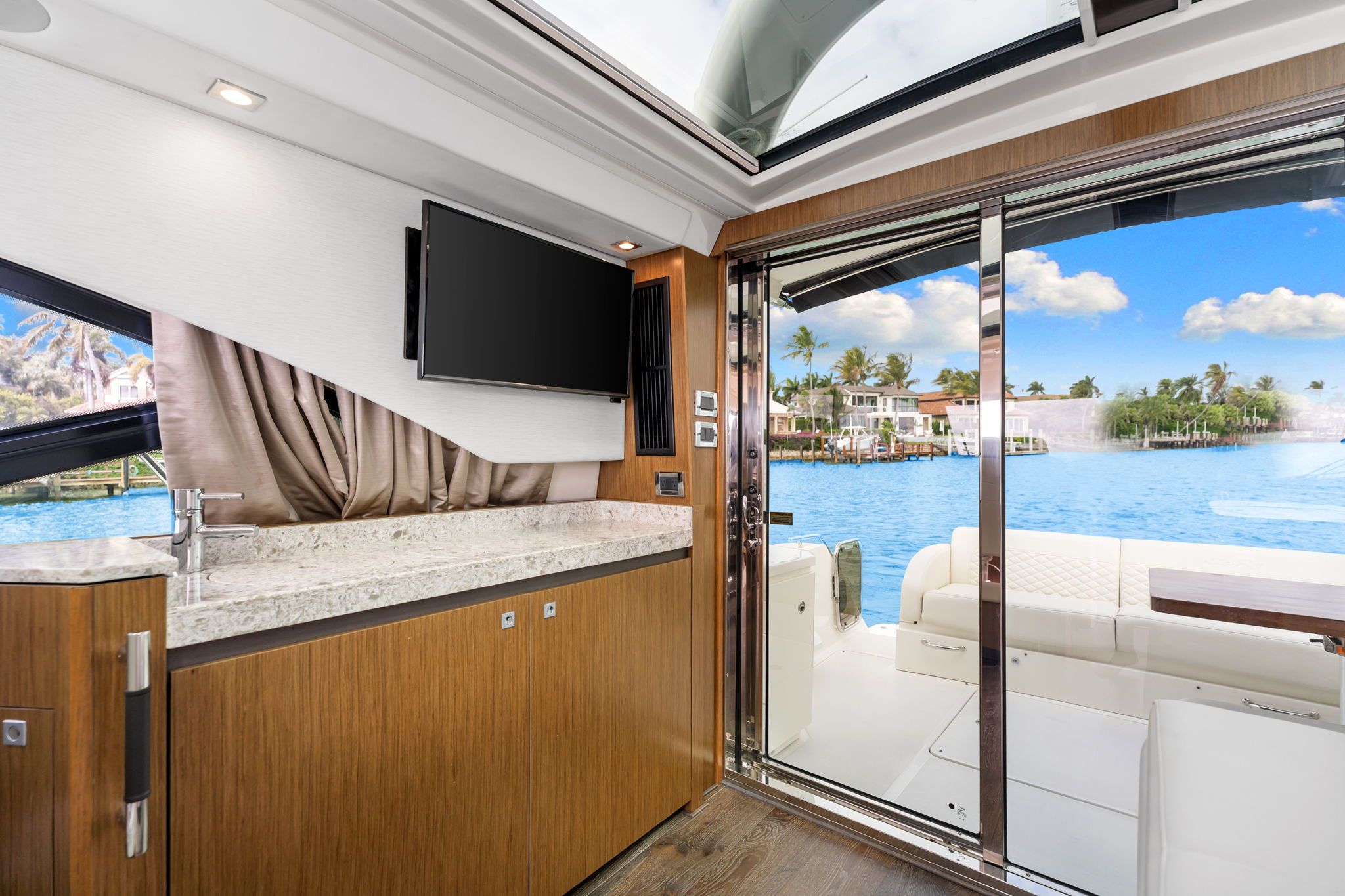 Interior of a 2017 Sea Ray Sundancer 510 with modern kitchen and view of the water.