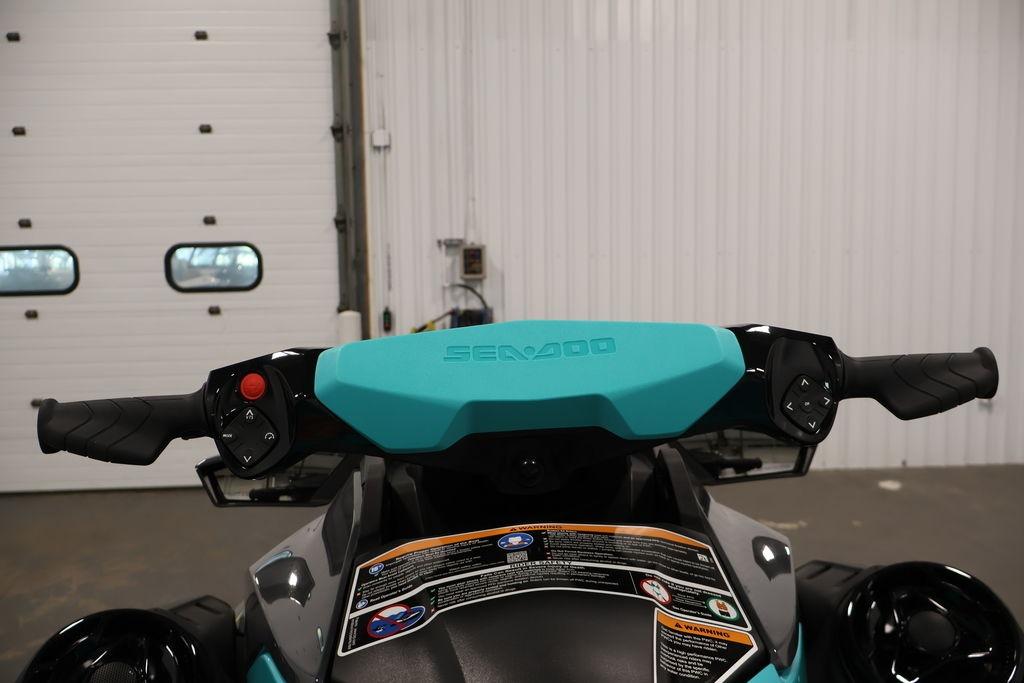 2026 Sea-Doo GTR 230 handlebars in a garage setting, showcasing controls and design.