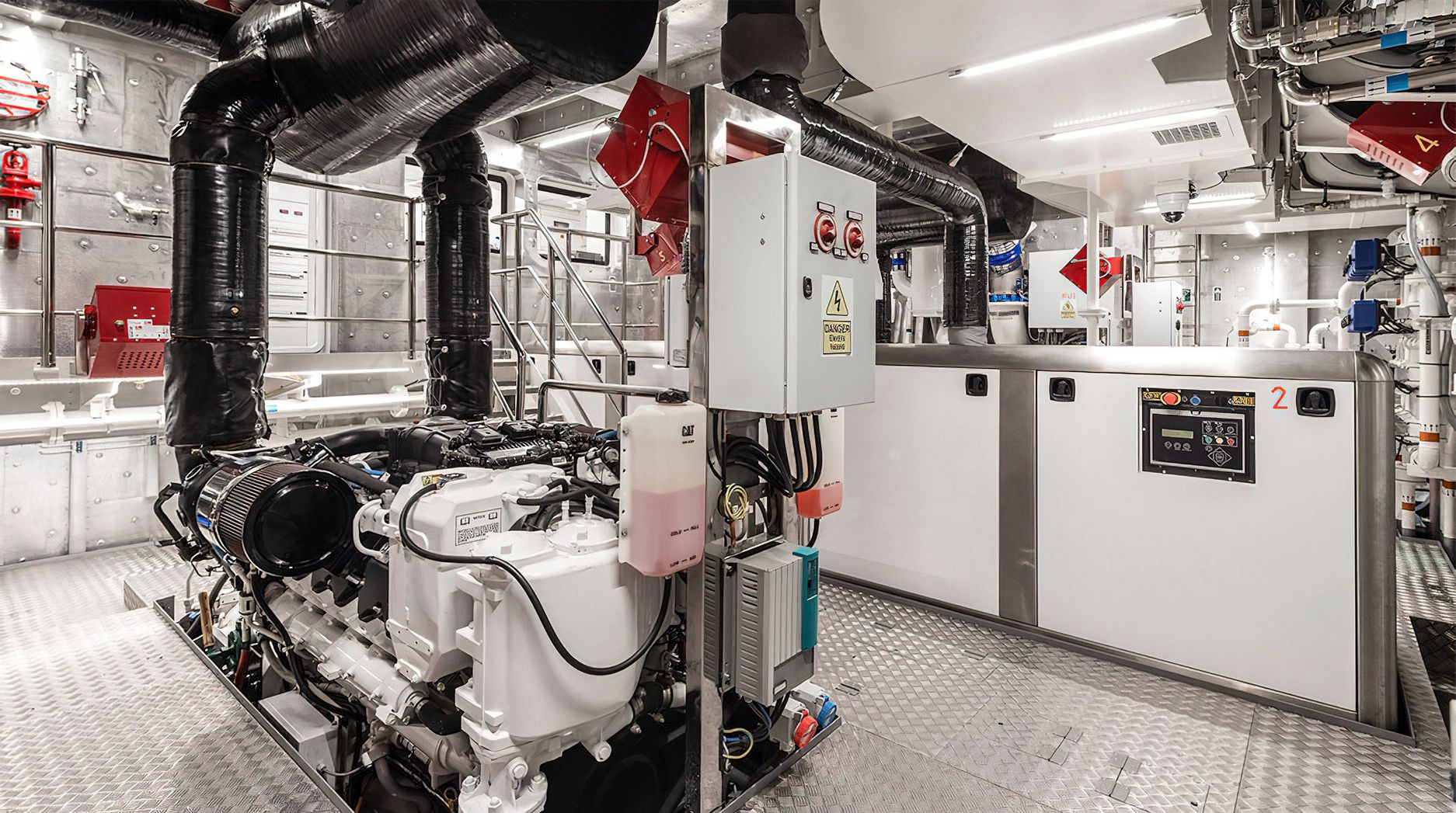 The engine room of the Ocean King Explorer 130 features complex machinery and piping.