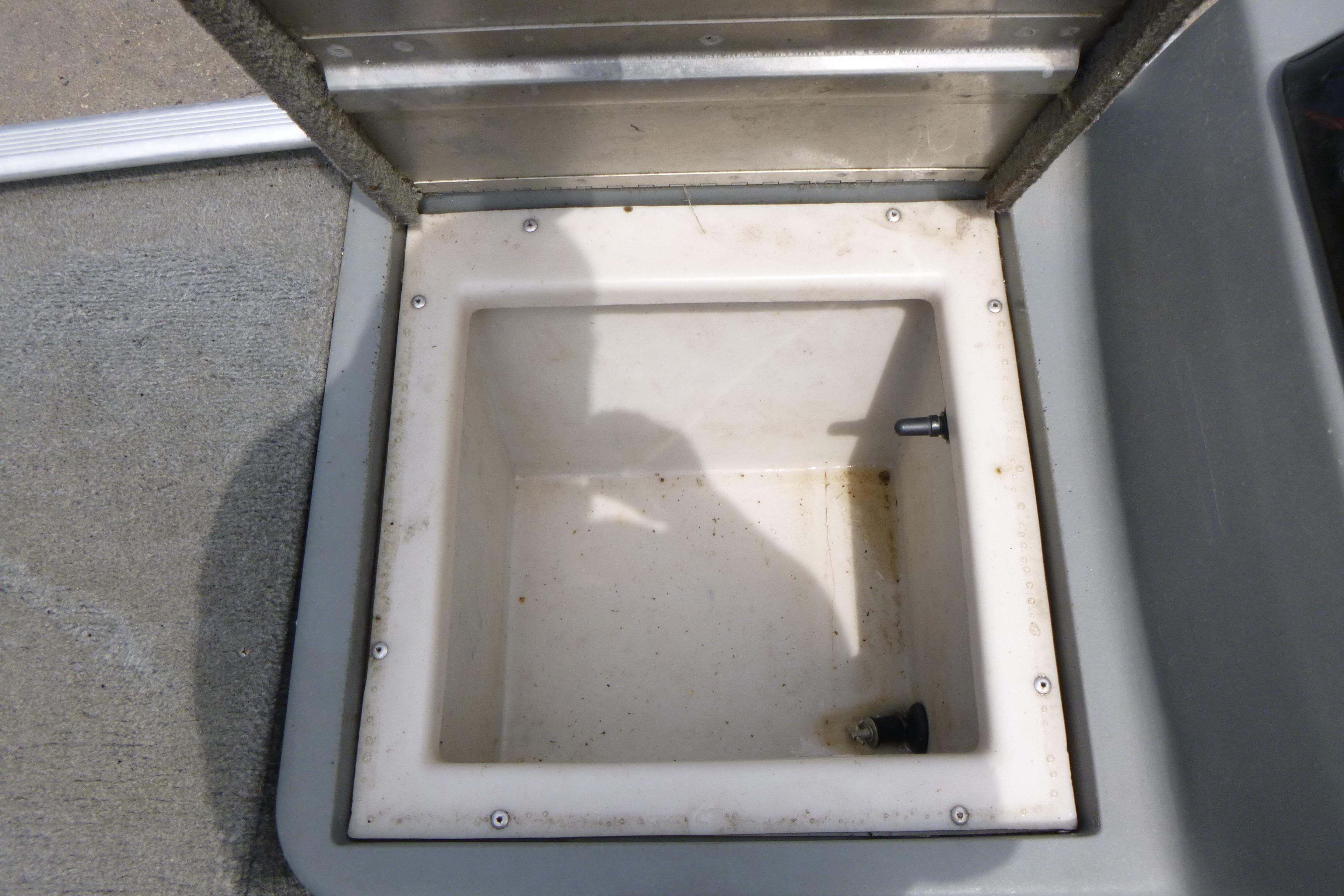 Open storage compartment in 2011 Tracker Pro Angler 16 boat.