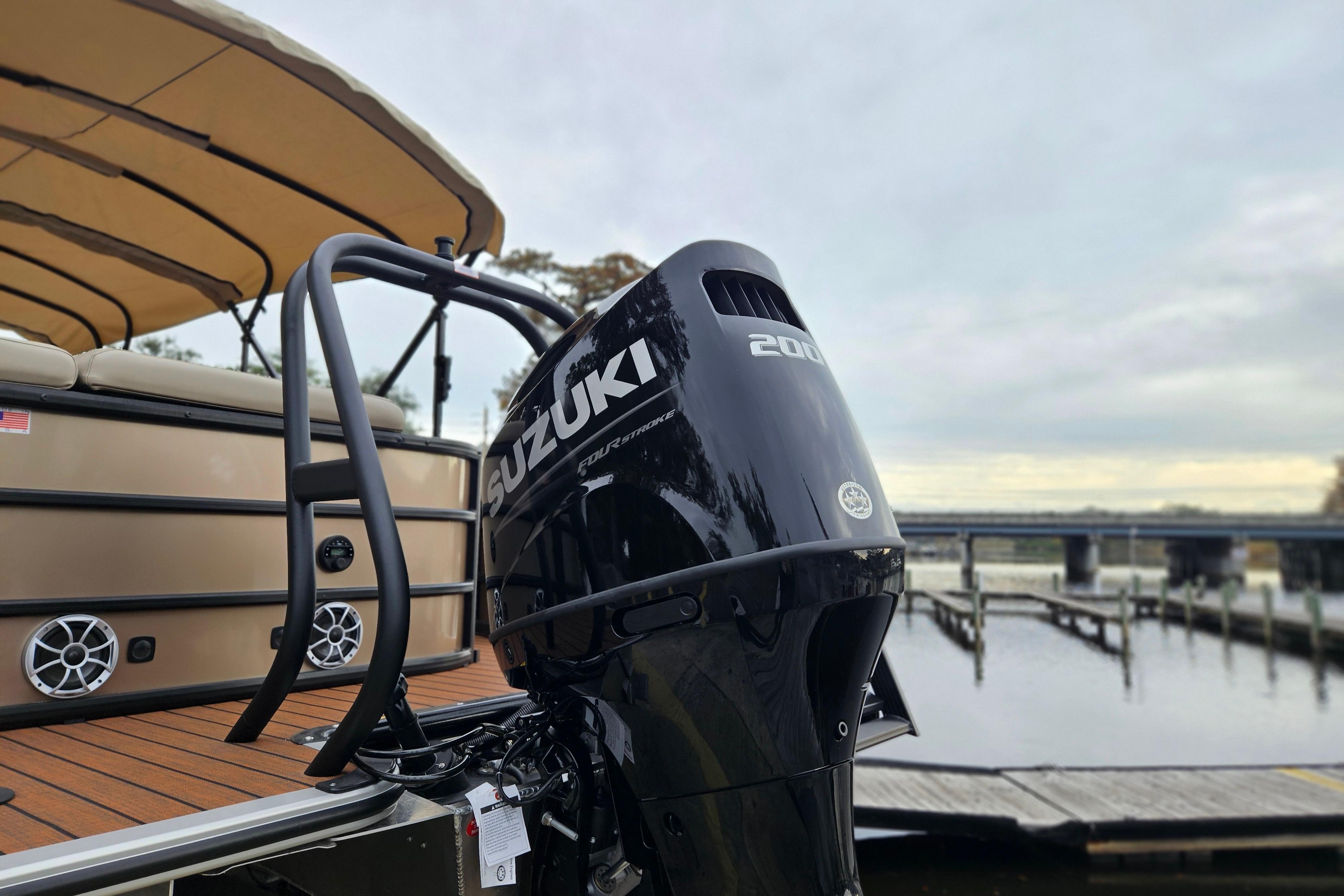 2026 Bentley Pontoons Legacy 243 Cruise with Suzuki engine at a dockside view.