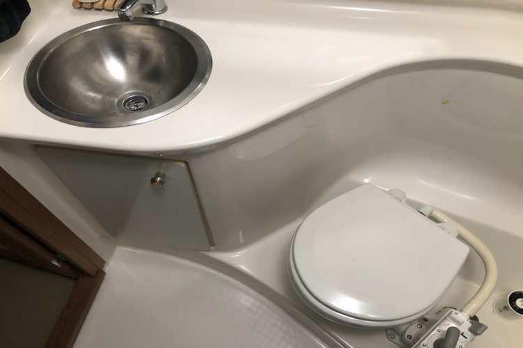 Bathroom interior of 1997 Bayliner 3988 Motoryacht with sink and toilet.