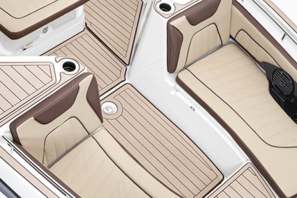 2026 Yamaha Boats 255 FSH Sport E interior with beige and brown seating and flooring.