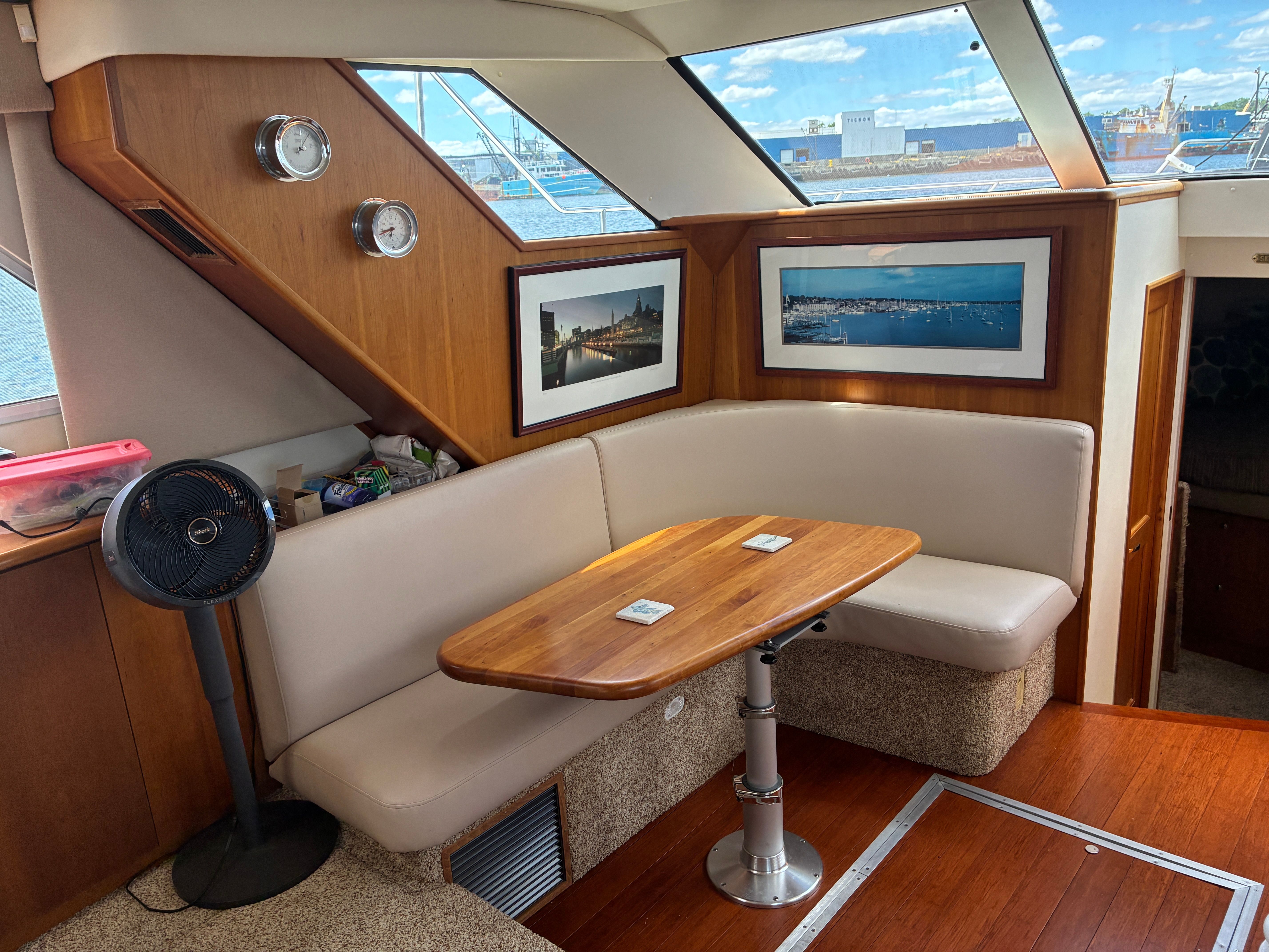 Interior of a 2001 Silverton 392 Motor Yacht with a cozy seating area and wooden table.