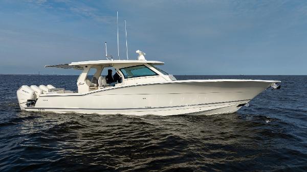 2025 Scout 425 LXF boat cruising on open water under a clear sky.