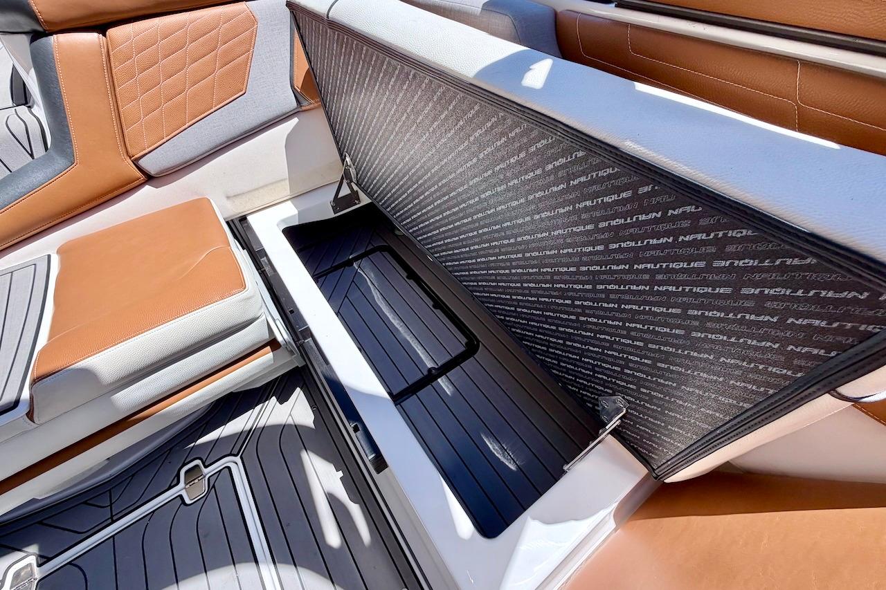 2021 Nautique Super Air Nautique G23 interior storage compartment with premium seating.