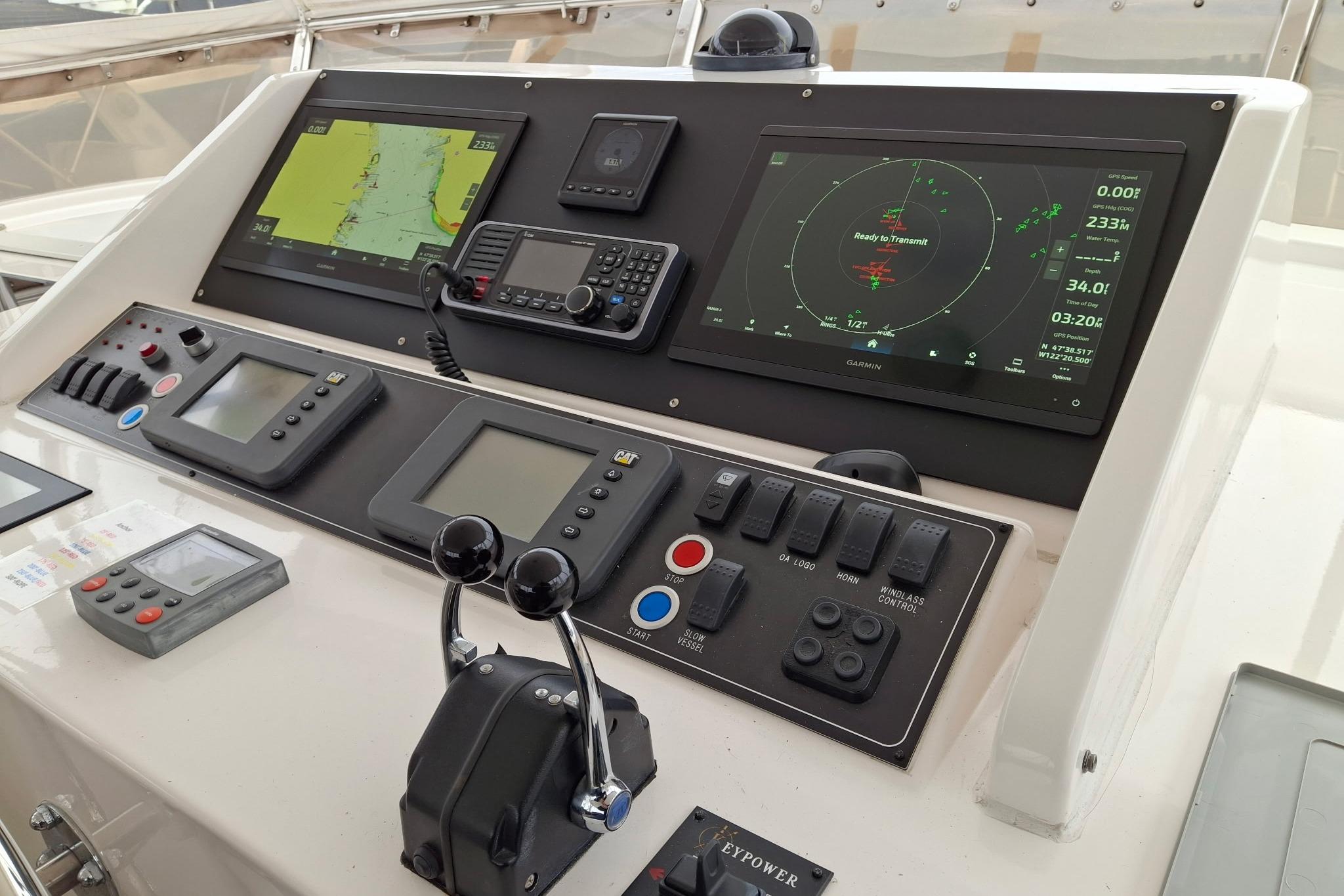 Control panel of a 2004 Ocean Alexander 64 Pilothouse yacht with navigation displays.