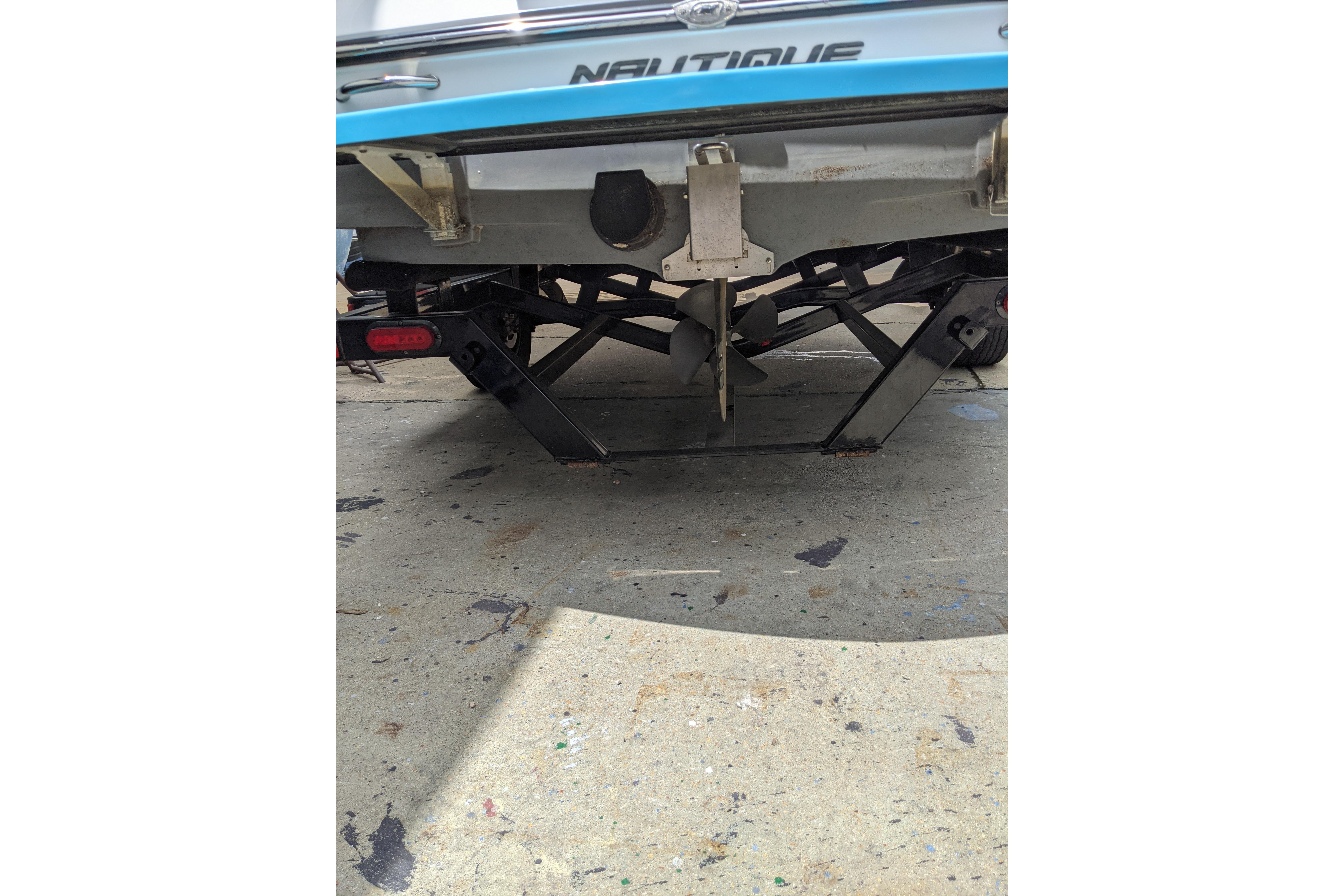 Rear view of a 2016 Nautique Ski Nautique 200 Closed Bow boat on a trailer.