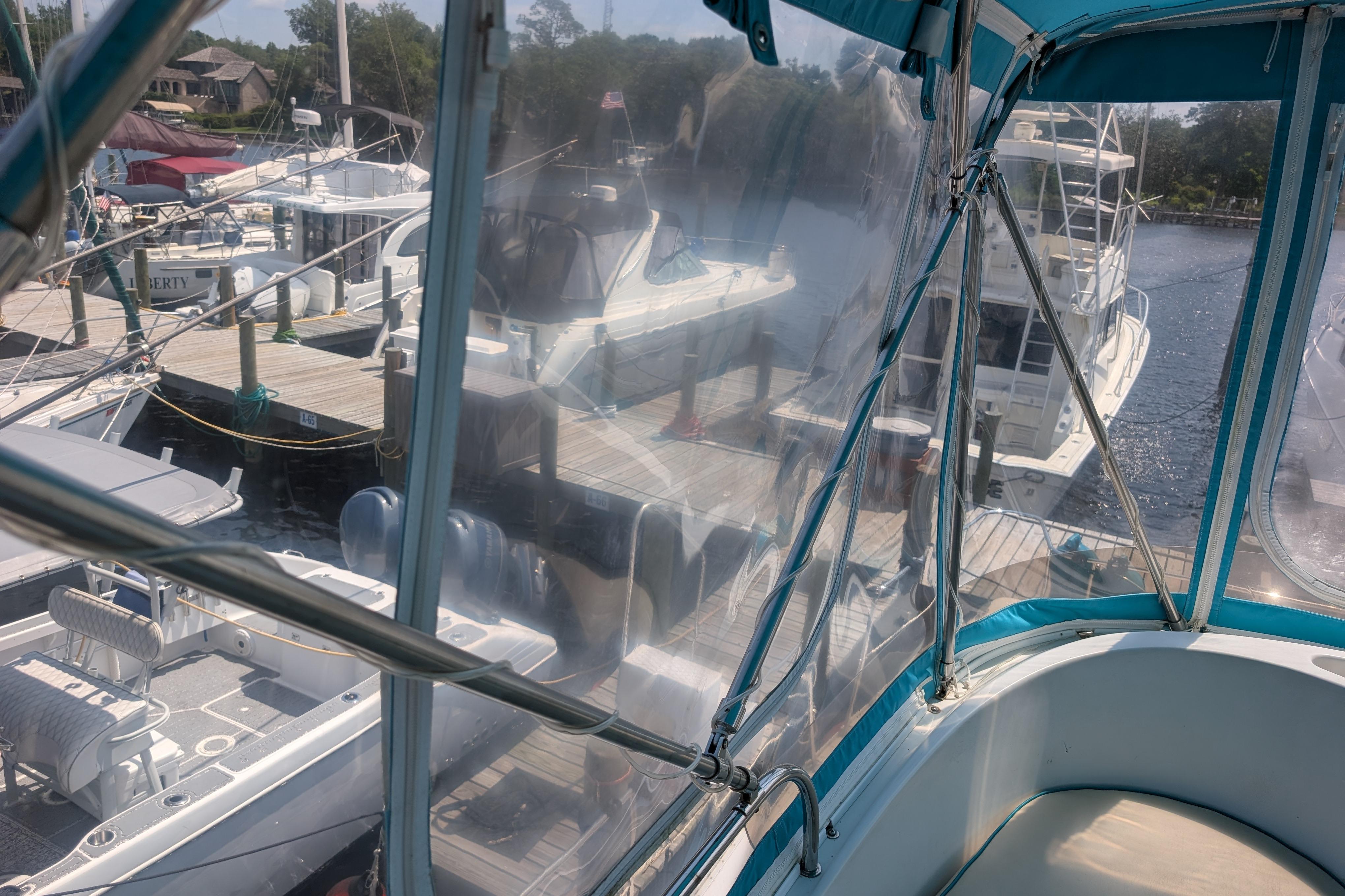 2004 PDQ 34 Powercat docked at marina, view from enclosed cockpit.
