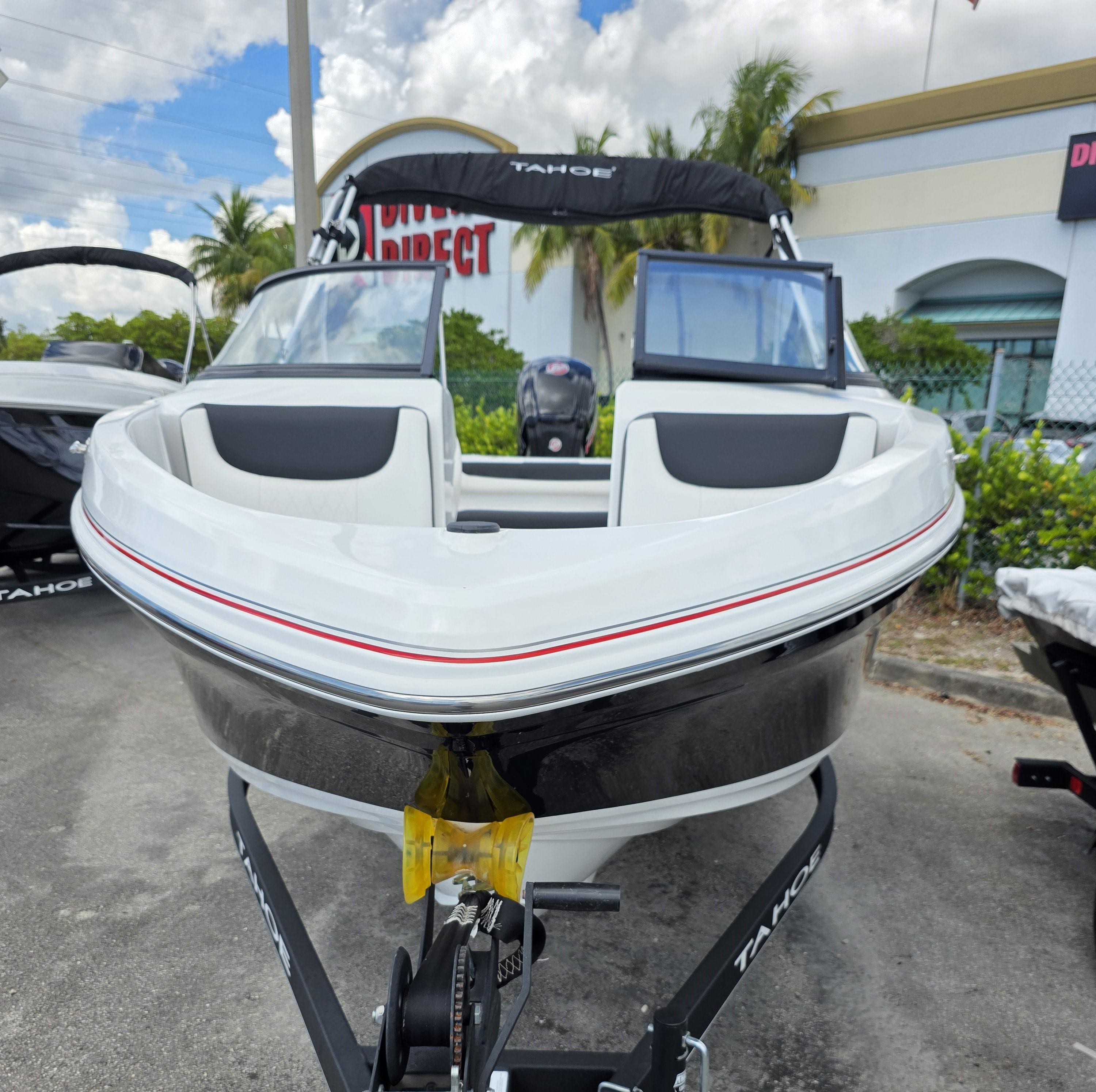 2024 Tahoe 185 S boat on trailer, front view, outdoors, under cloudy sky.