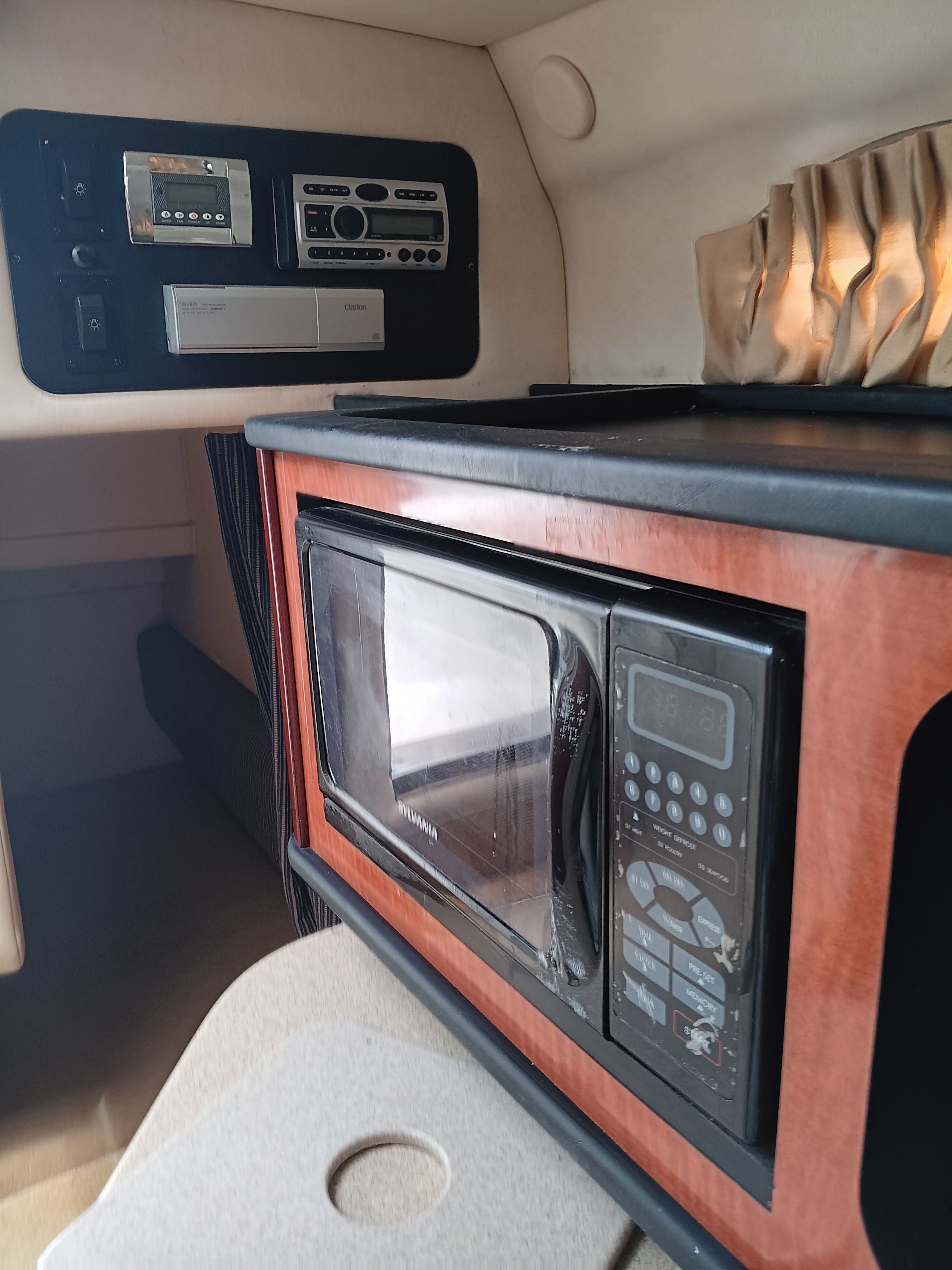 Interior of the Sea Ray 260 DA Sundancer with microwave and control panel.