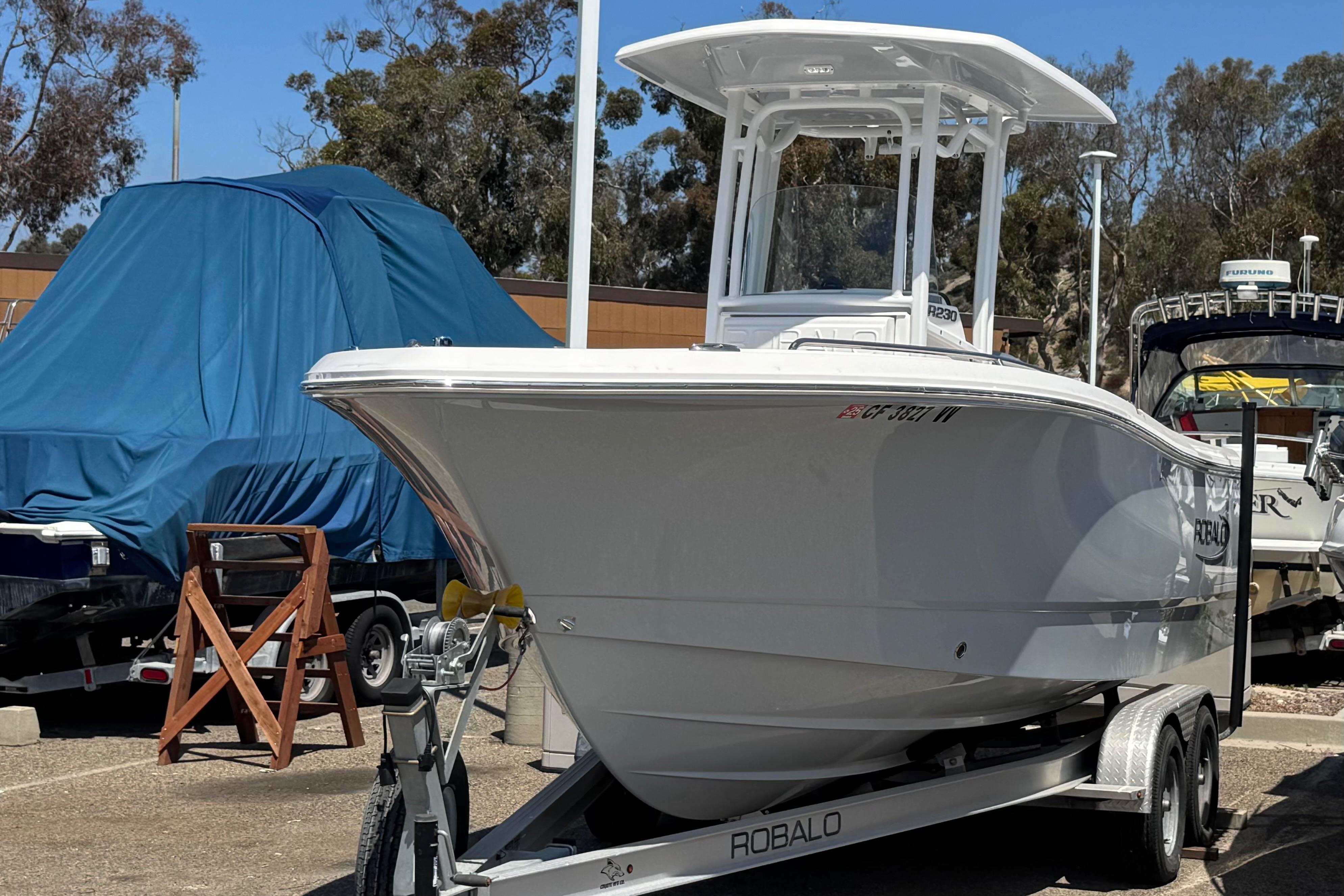 2022 Robalo R230 Center Console boat on trailer in outdoor setting.