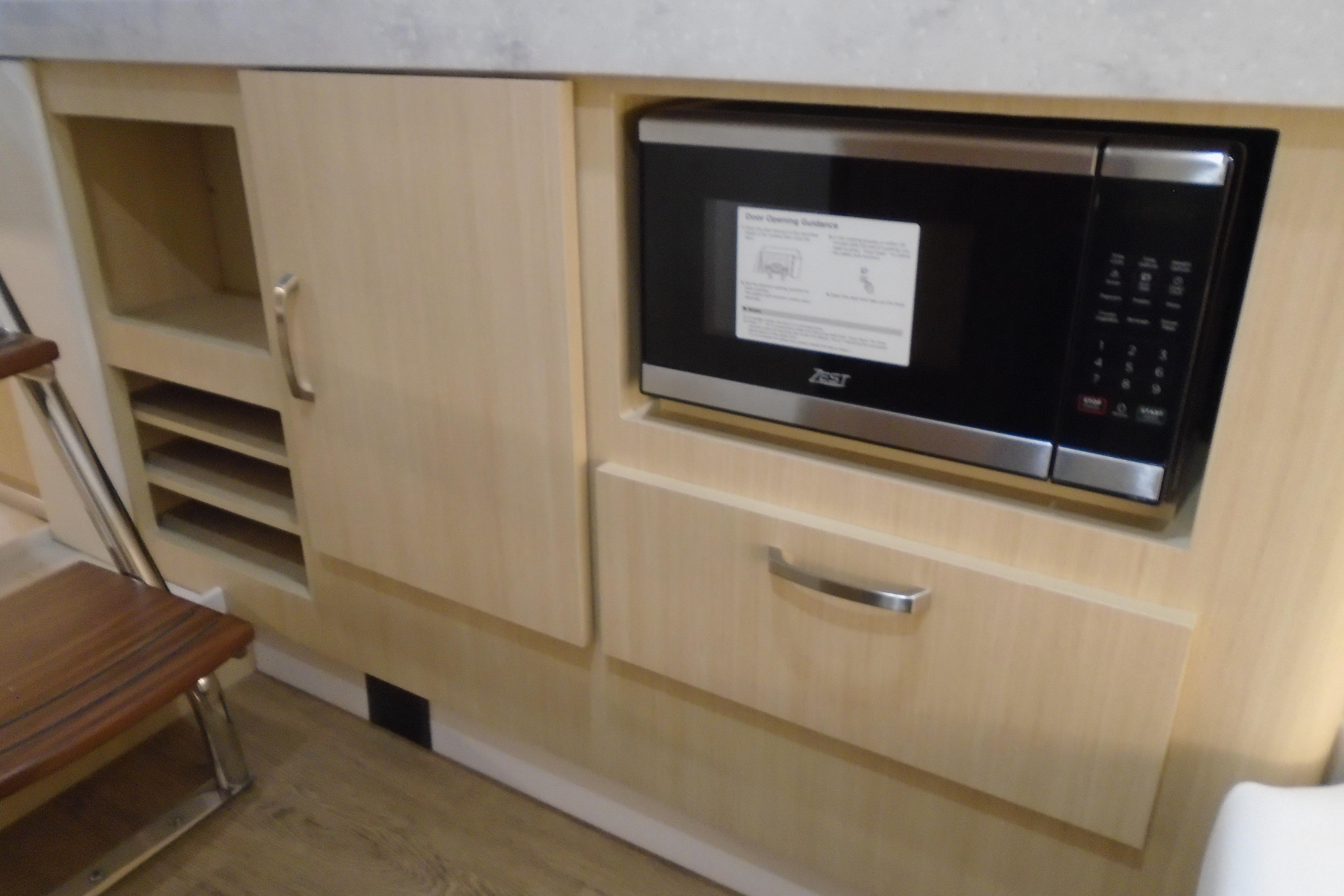 Built-in microwave and cabinetry in 2026 Regal 38 SAV boat interior.