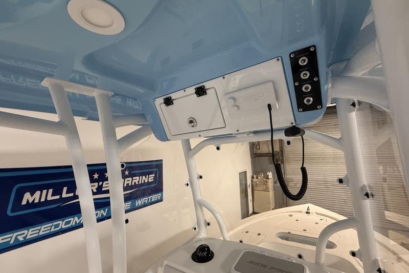 Interior view of a 2026 Sea Pro 250 Bay boat with control panel and storage.
