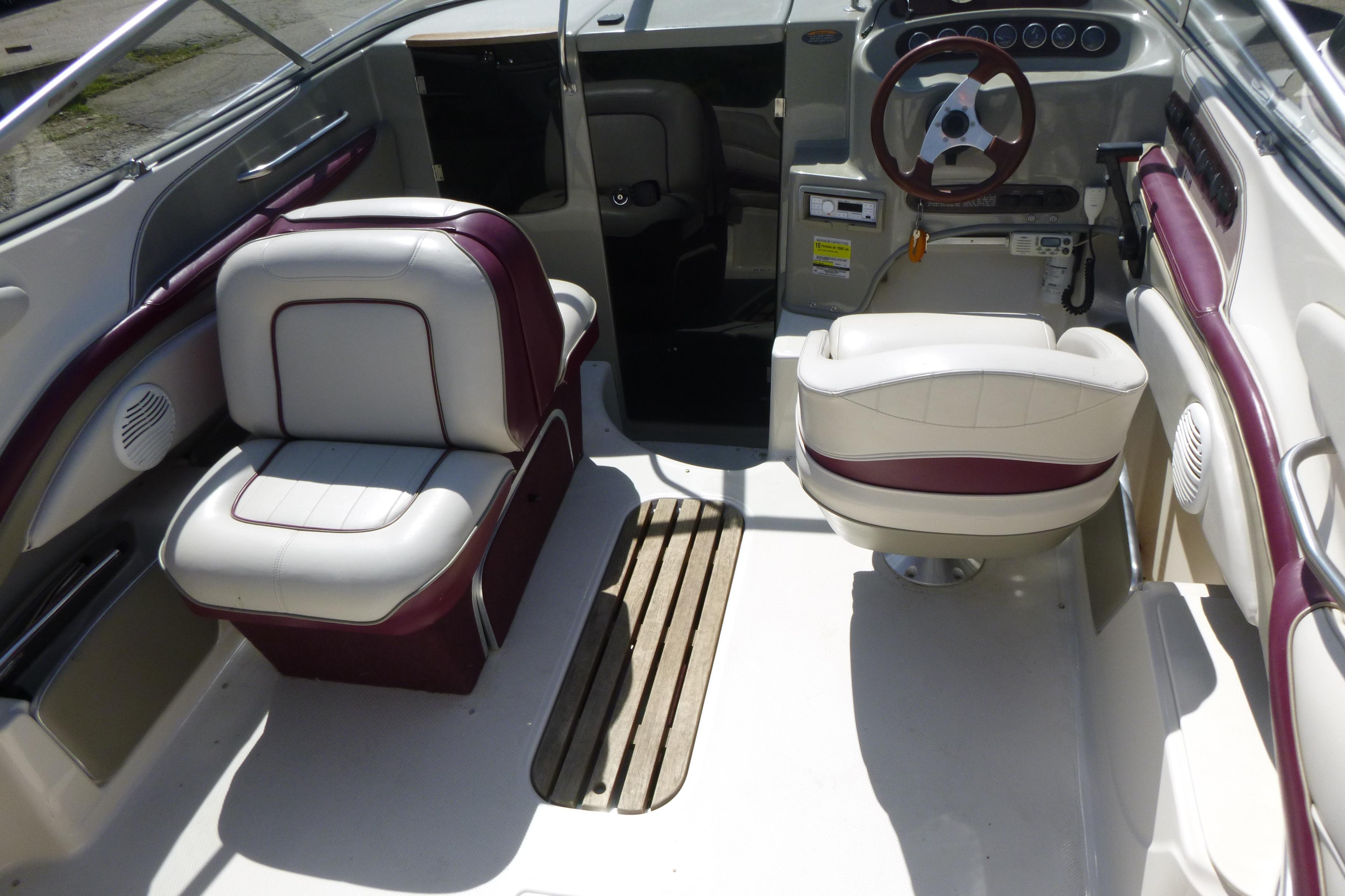 Interior of a 1998 Maxum 2300 SC boat with white and maroon seating.