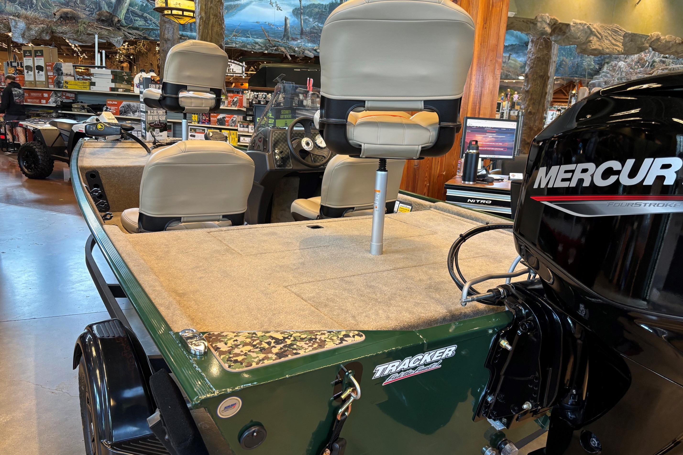 2026 Tracker Bass Tracker Classic Limited boat with Mercury engine in showroom.