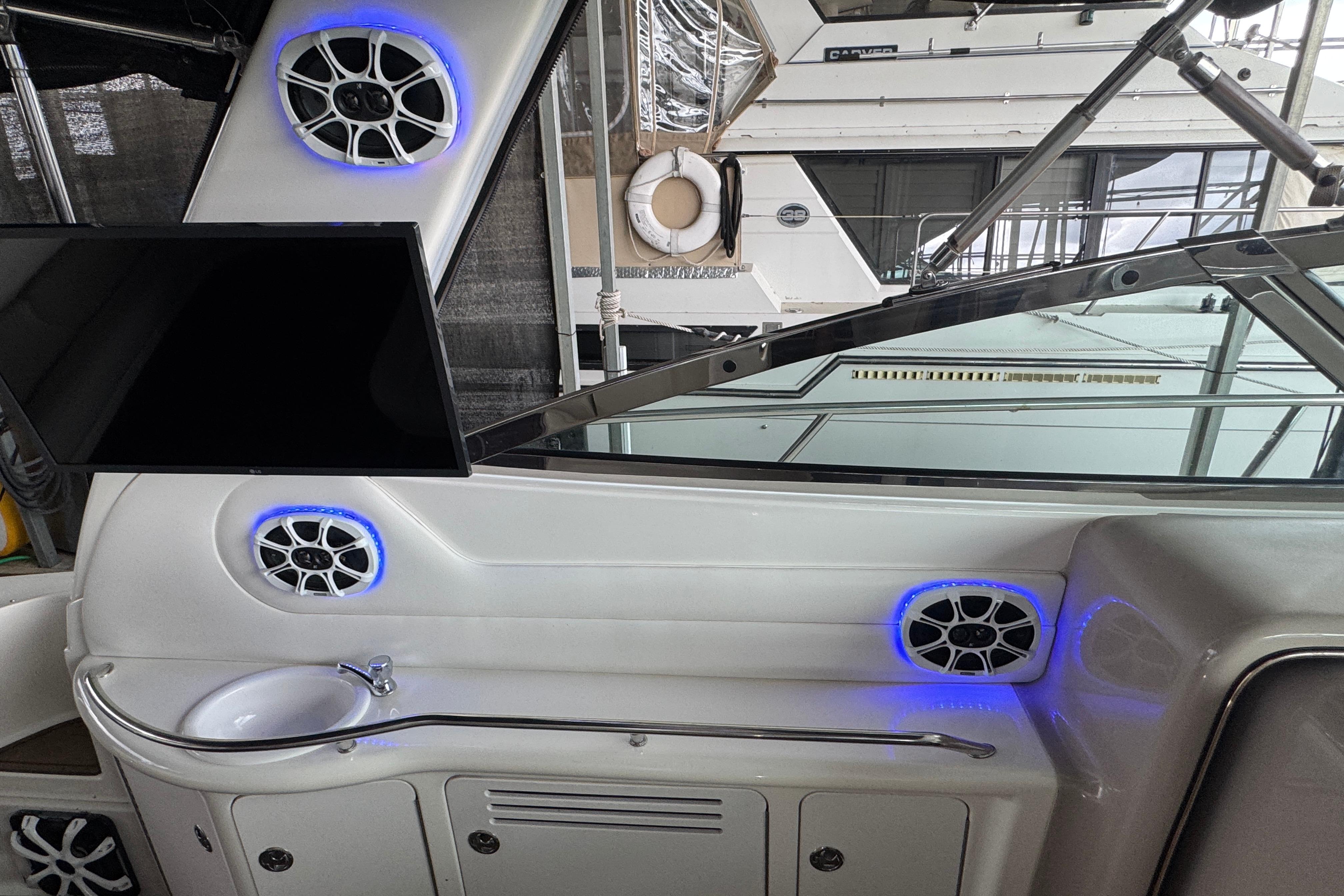 Interior of 2001 Sea Ray 380 Sundancer with speakers, TV, and sink.