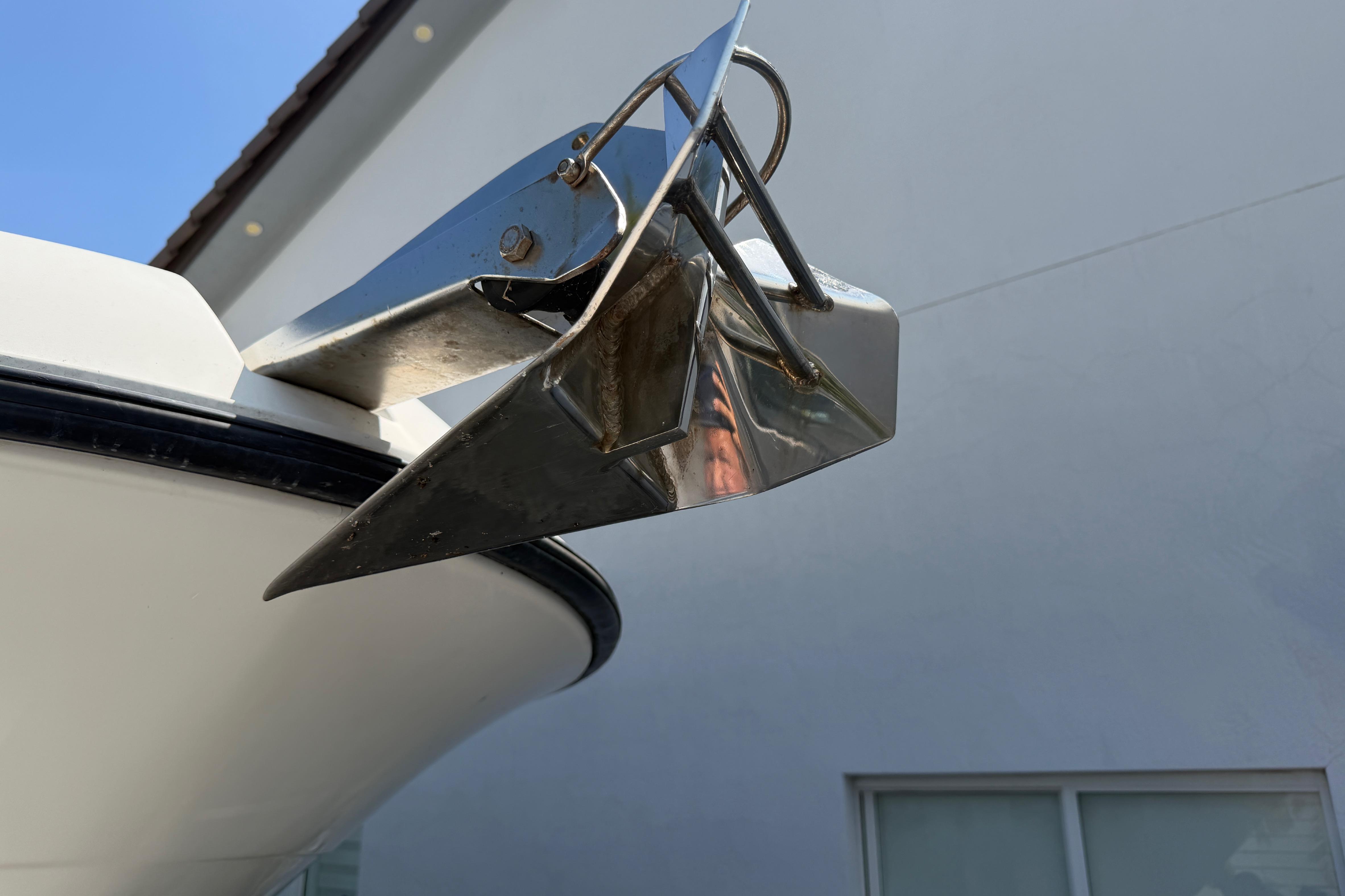 Close-up of a 2008 Hydra-Sports Vector 2900 CC boat anchor against a building background.