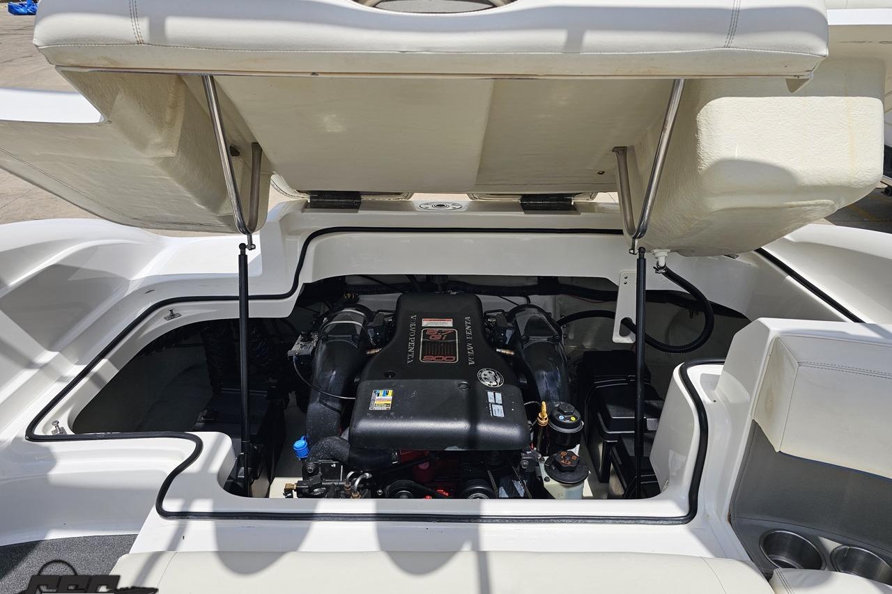 Open engine compartment of a 2010 Cobalt 232 WSS boat, showcasing the engine details.